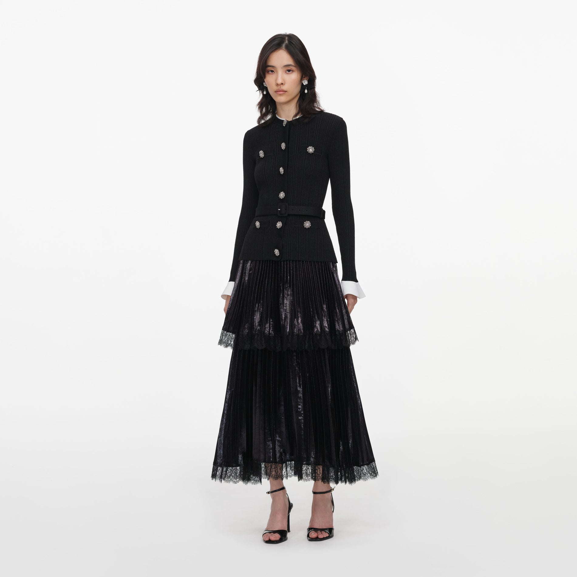 Side view of a woman wearing the Black Knit Metallic Chiffon Midi Dress