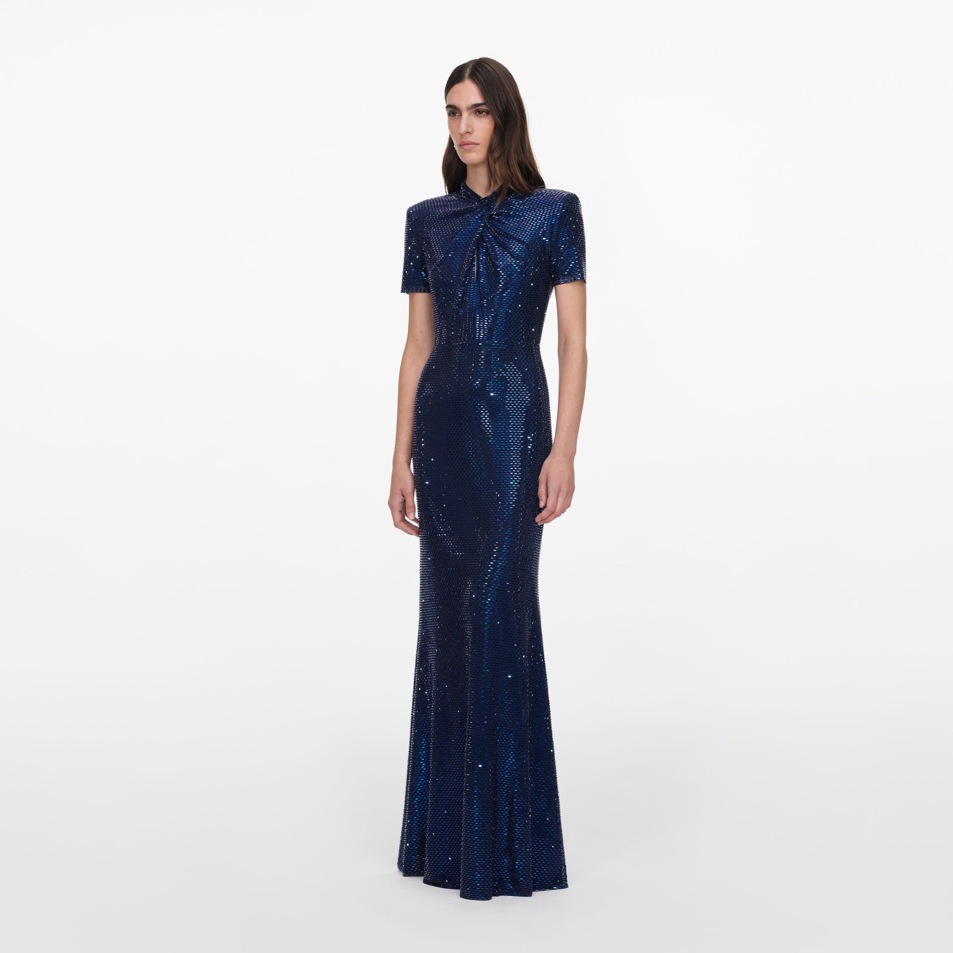 Side view of a woman wearing the Navy Rhinestone Mesh Twist Maxi Dress