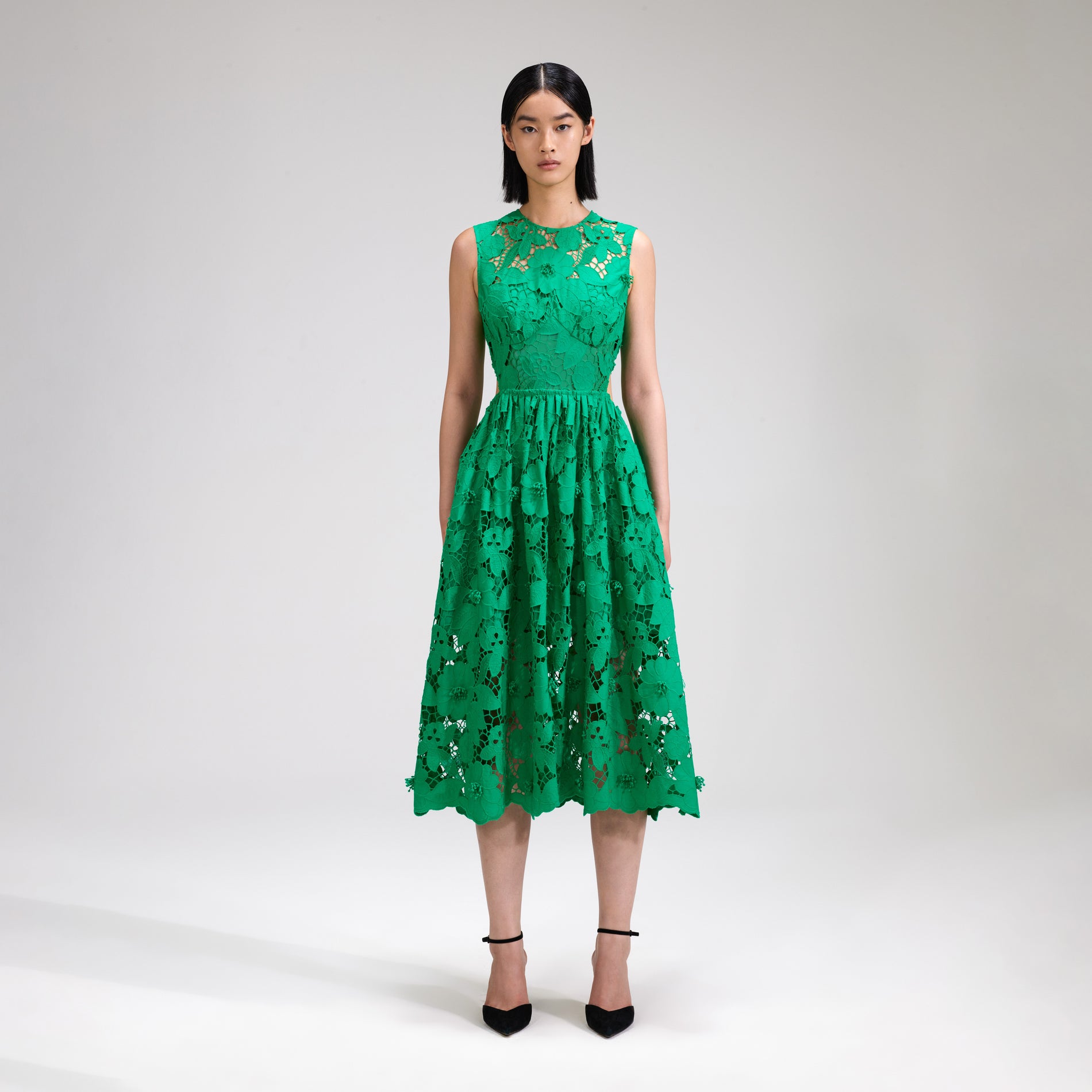 A woman wearing the Green 3D Cotton Lace Midi Dress