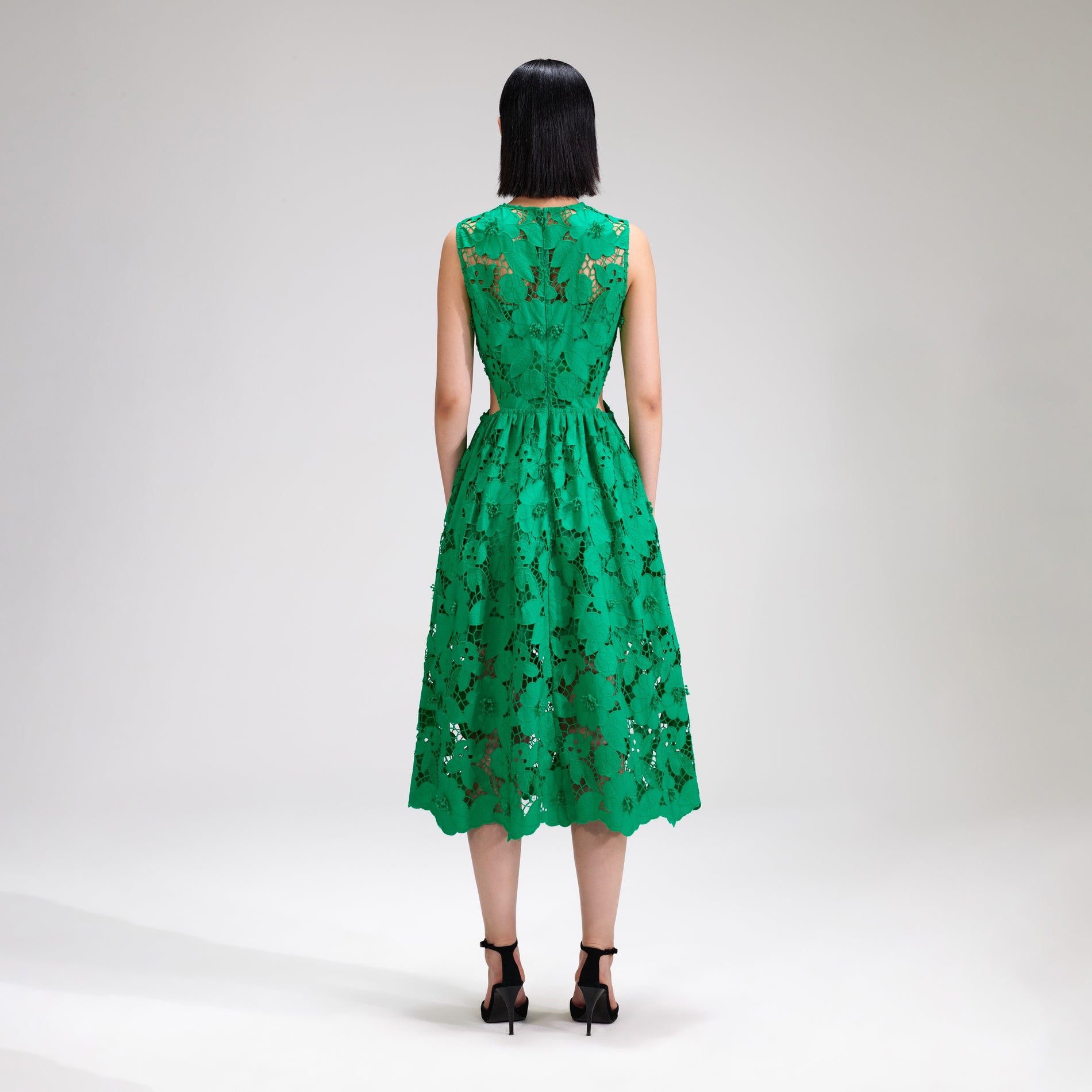 A woman wearing the Green 3D Cotton Lace Midi Dress