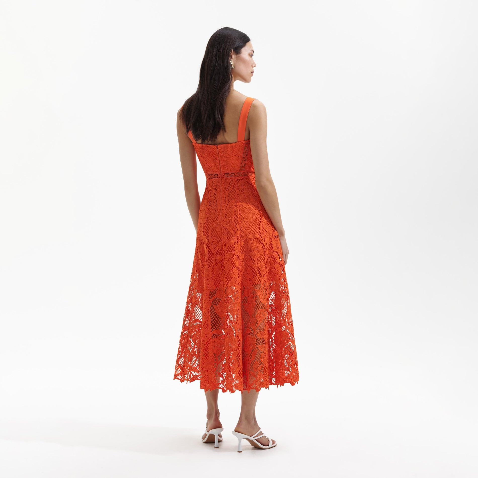 Back view of a woman wearing the Orange Lace Midi Dress