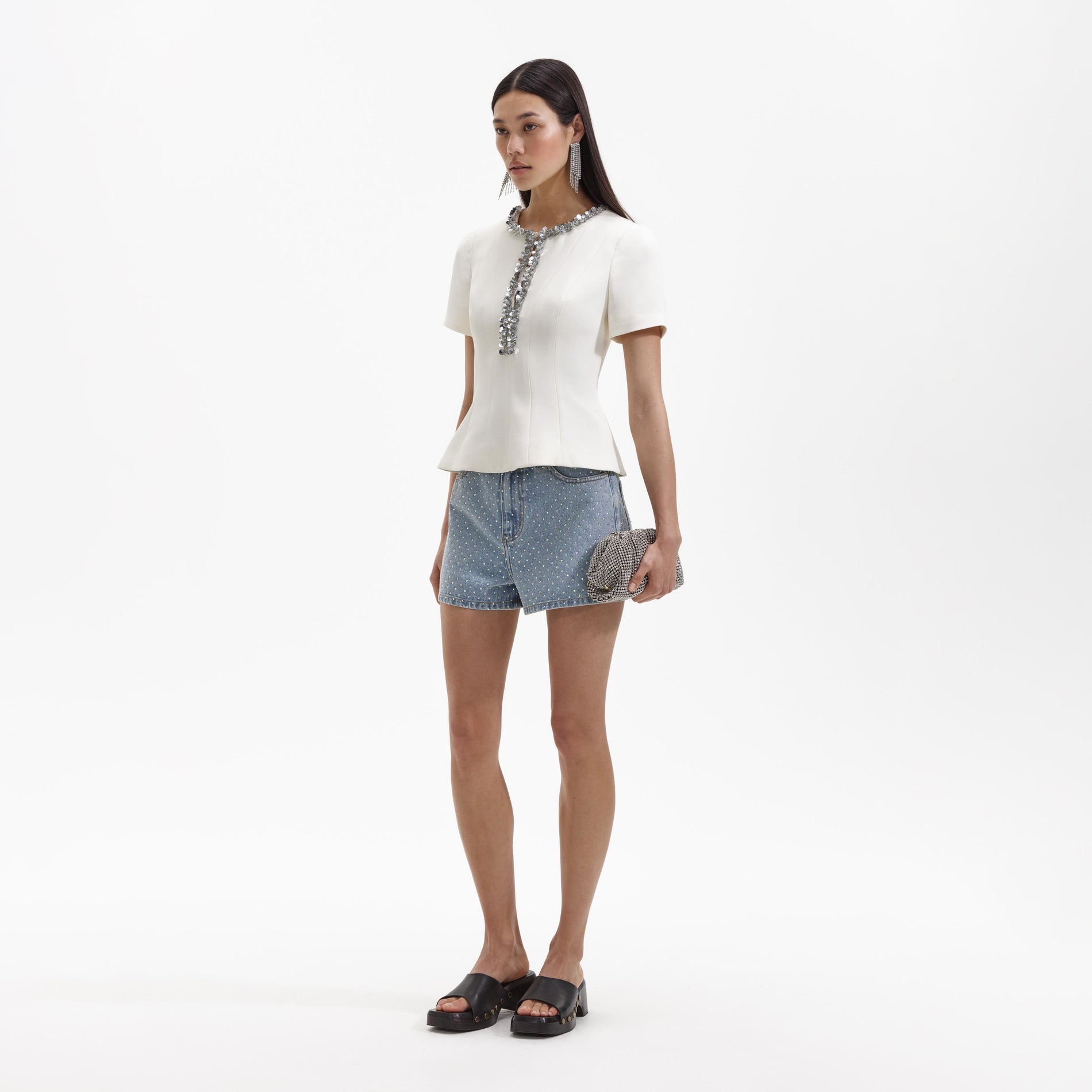 Side view of a woman wearing the Cream Crepe Embellished Top