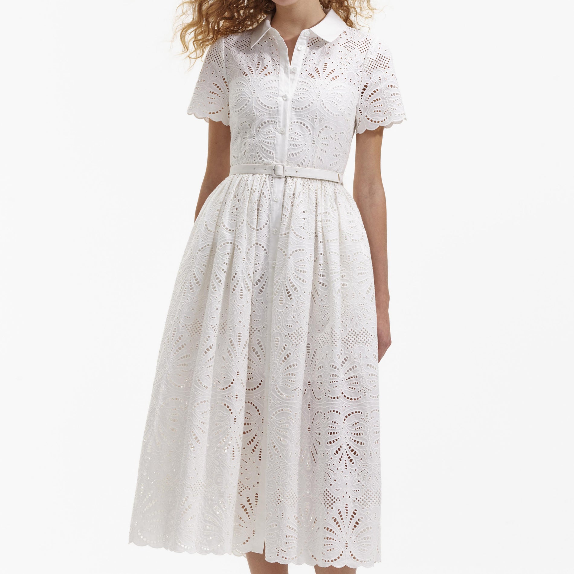 A close up of a woman wearing the White Cotton Embroidery Midi Dress