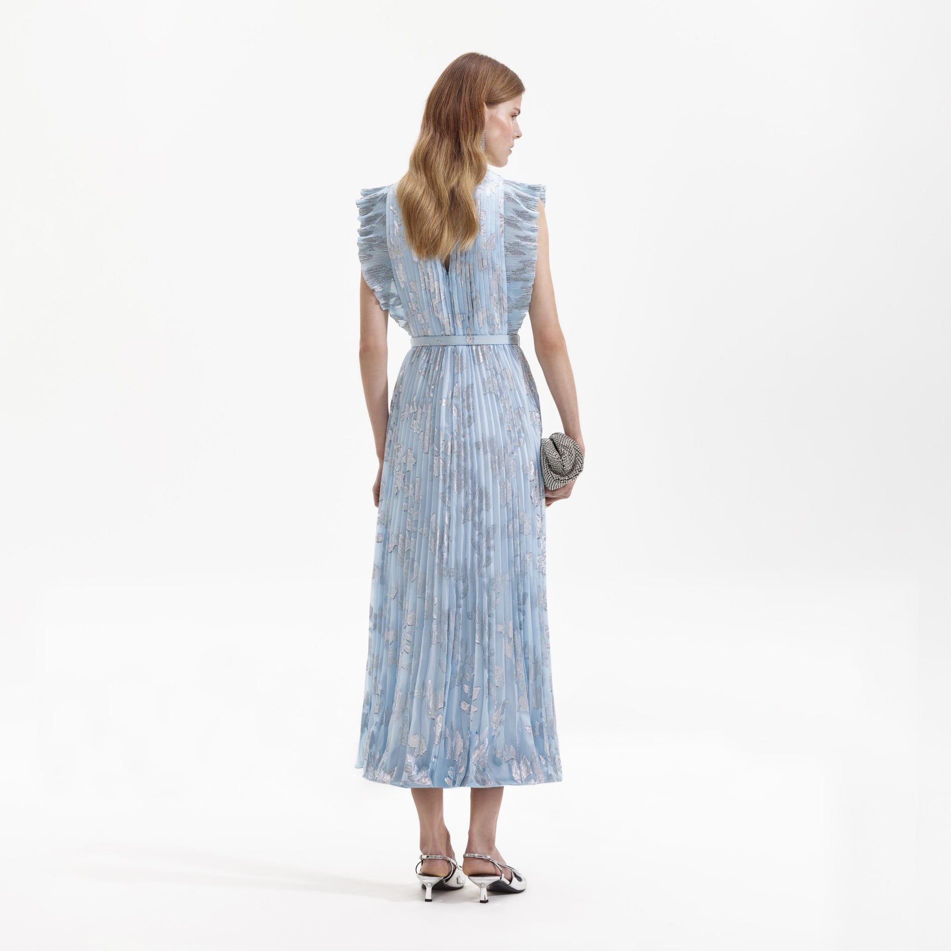 Side view of a woman wearing the Blue Metallic Floral Midi Dress