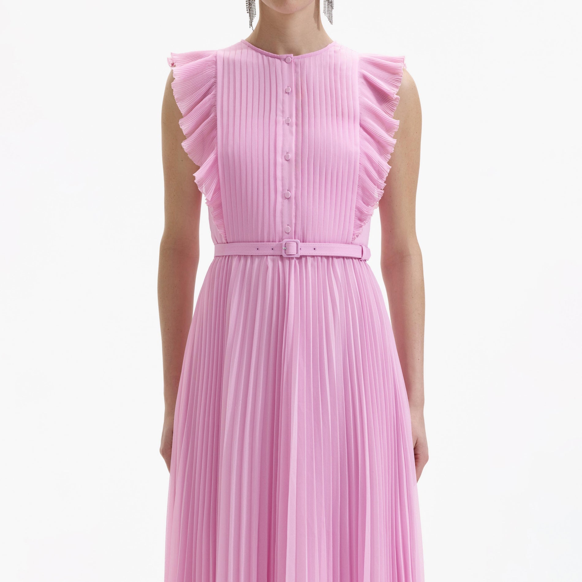 A close up of a woman wearing the Pink Chiffon Sleeveless Tunic Ruffle Midi Dress