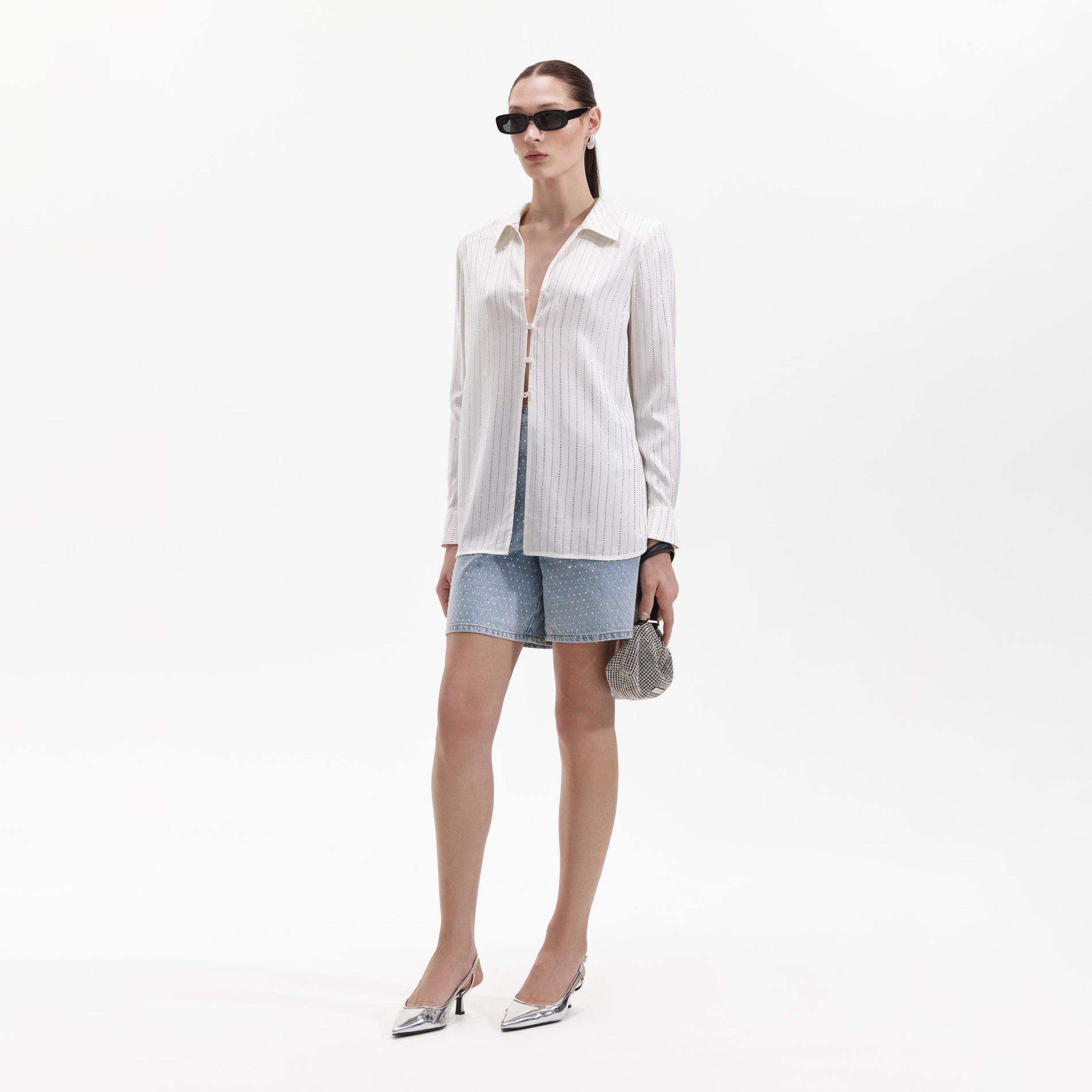 Side view of a woman wearing the White Rhinestone Stripe Shirt