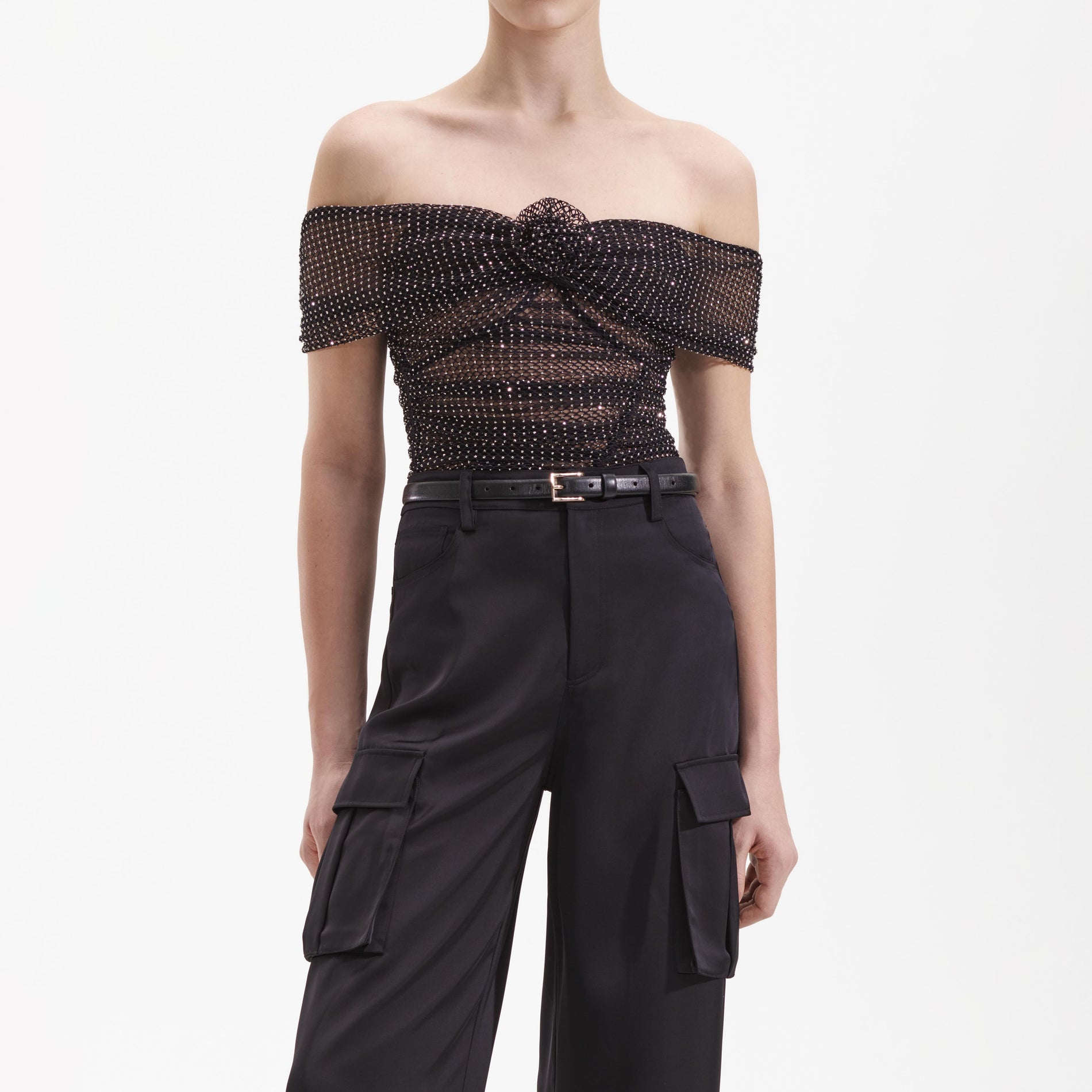 A close up of a woman wearing the Black Satin Cargo Trouser