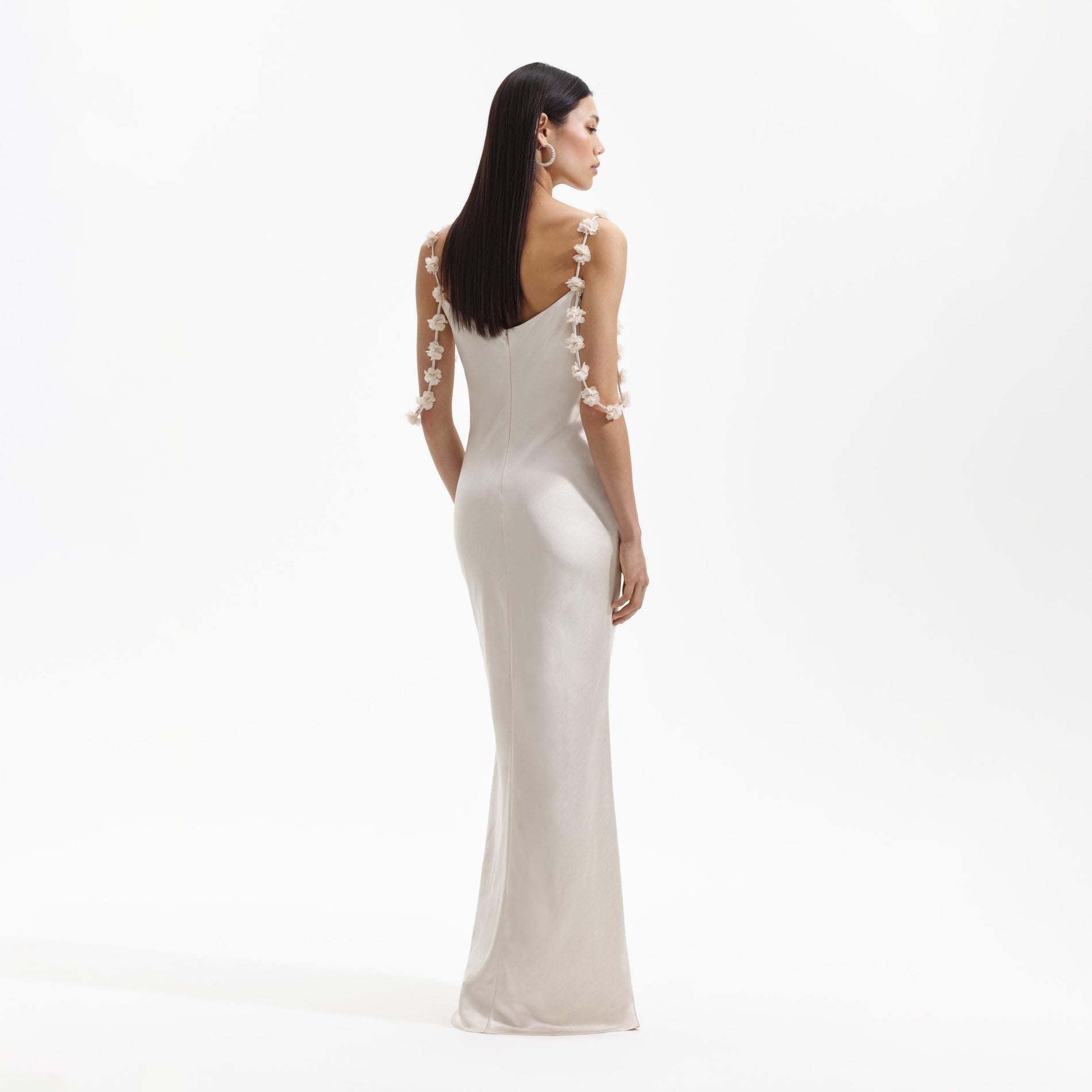 A Woman wearing the Champagne Satin Flower Maxi Dress
