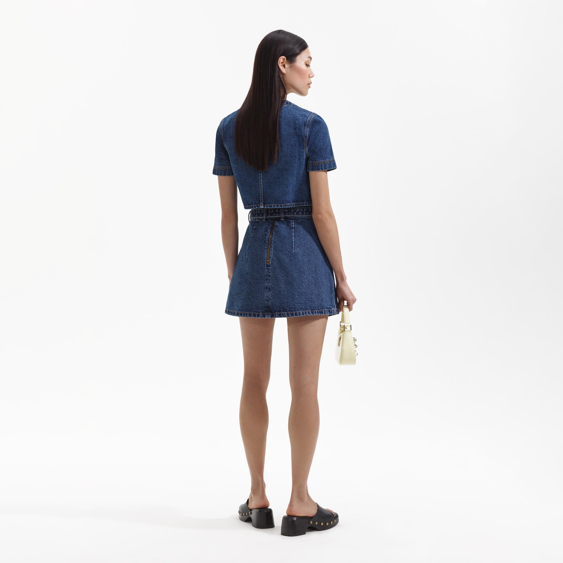 Back view of a woman wearing the Denim Short Sleeve Crop Top