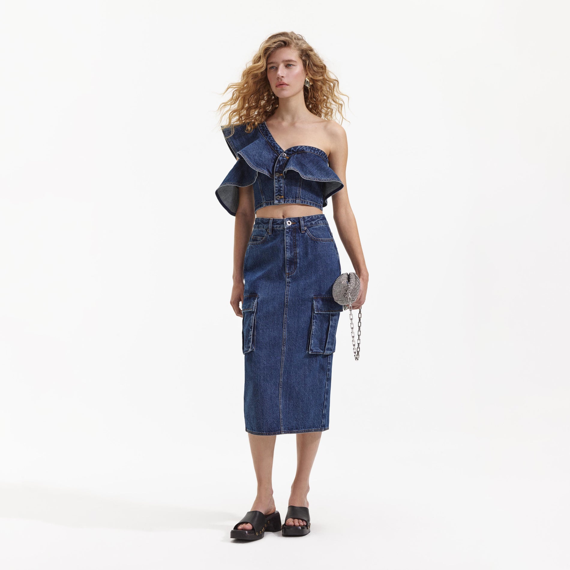 Side view of a woman wearing the Denim Cargo Midi Skirt