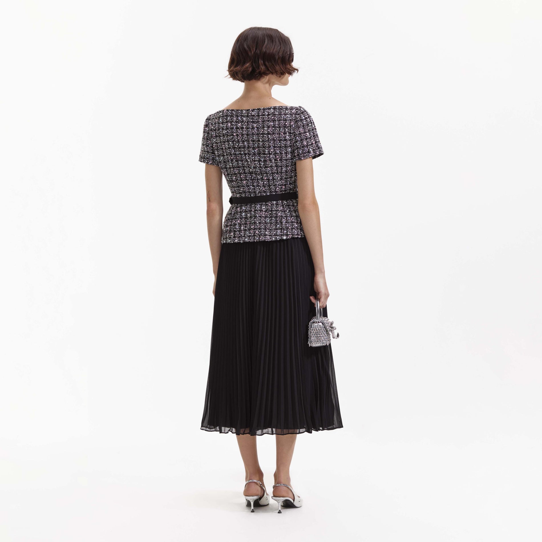 Back view of a woman wearing the Black Boucle Off Shoulder Midi Dress