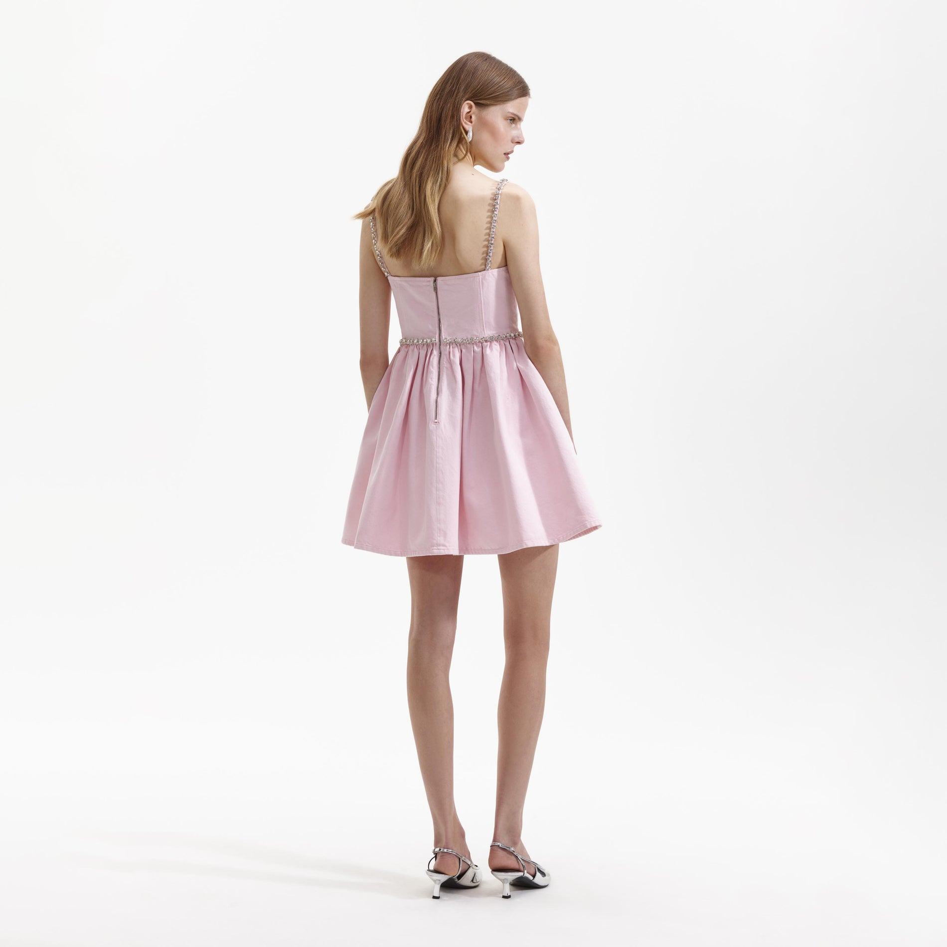 Back view of a woman wearing the Pink Diamante Denim Mini Dress
