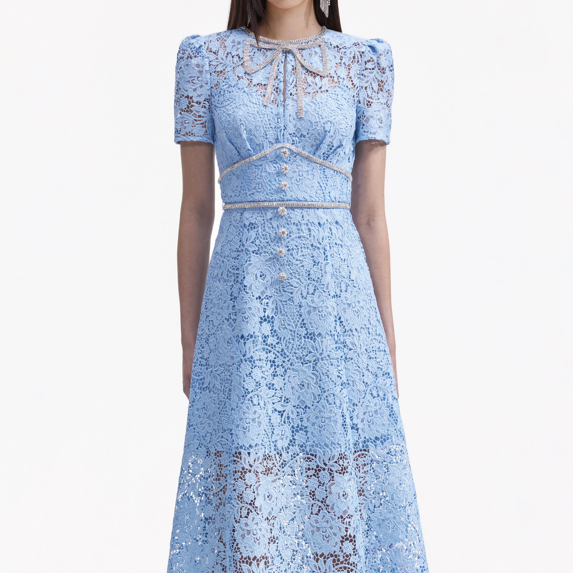 A close up of a woman wearing the Blue Cord Lace Bow Midi Dress