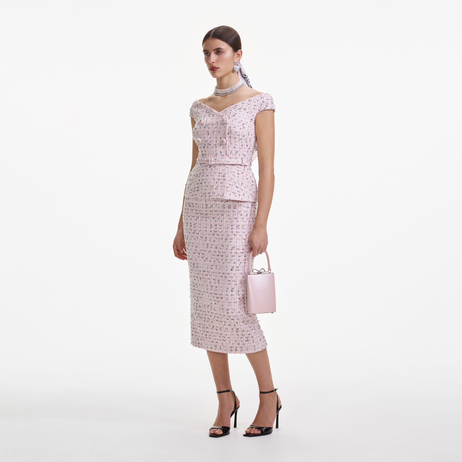 Side view of a woman wearing the Pink Boucle Pearl Midi Dress
