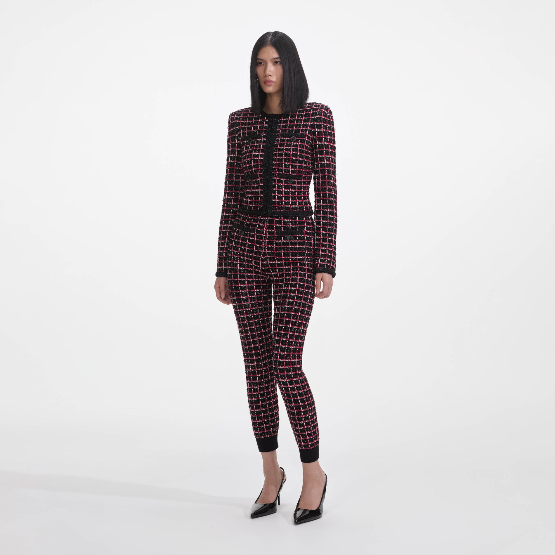 Side view of a woman wearing the Black And Red Check Knit Leggings