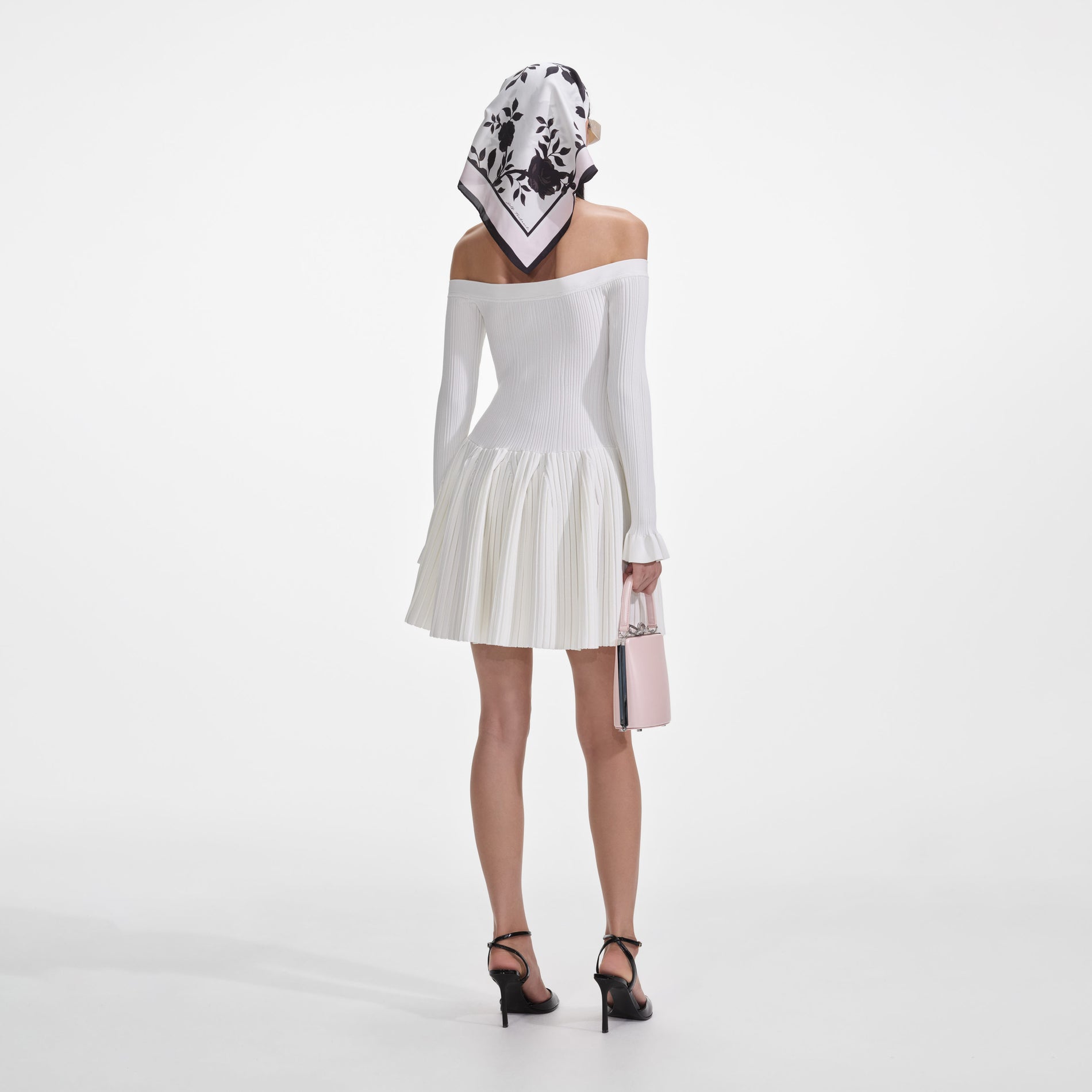 Back view of a woman wearing the White Ribbed Knit Mini Dress