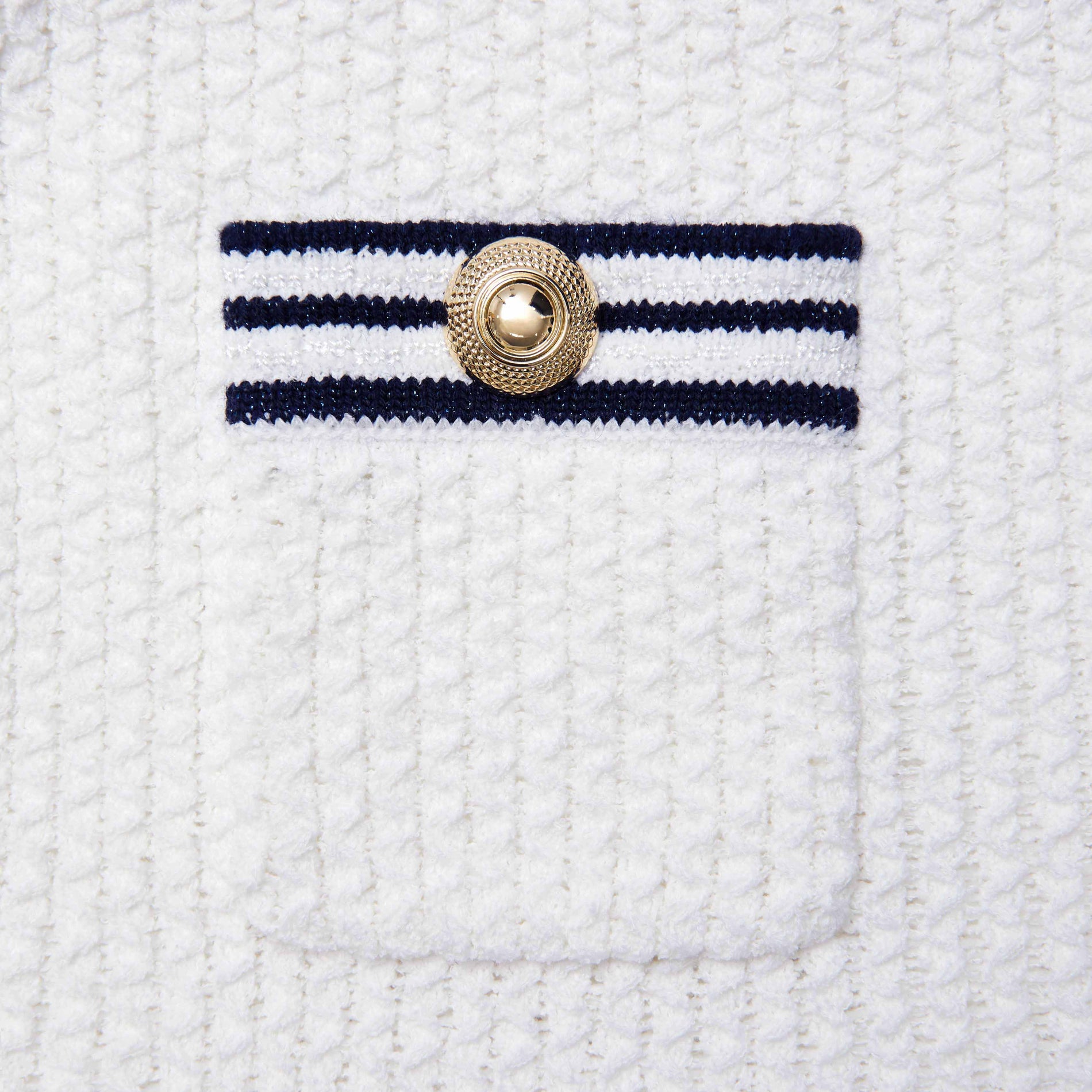 Side view of a woman wearing the White Textured Knit Mini Skirt