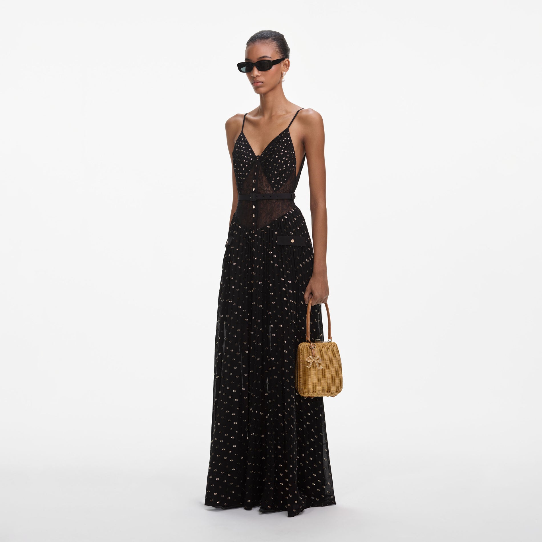 Side view of a woman wearing the Black And Gold Chiffon Maxi Dress