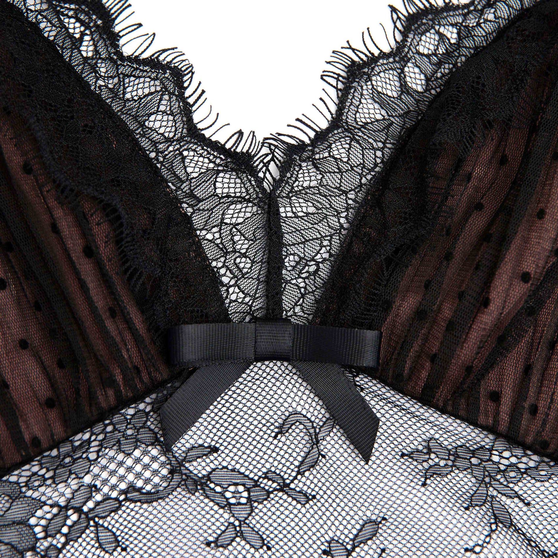 Side view of a woman wearing the Black Dot Mesh Bodysuit