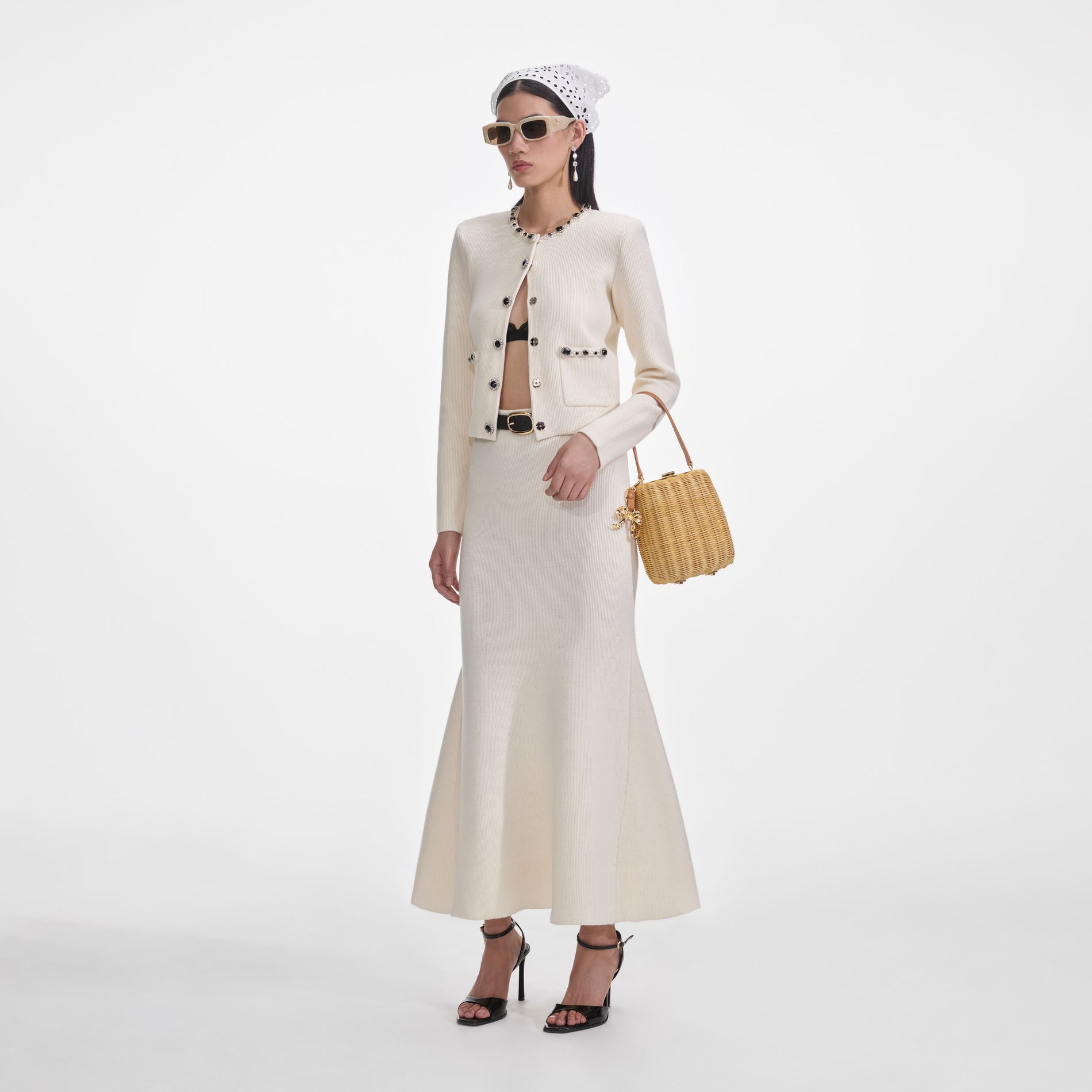 Side view of a woman wearing the Cream Flared Knit Midi Skirt