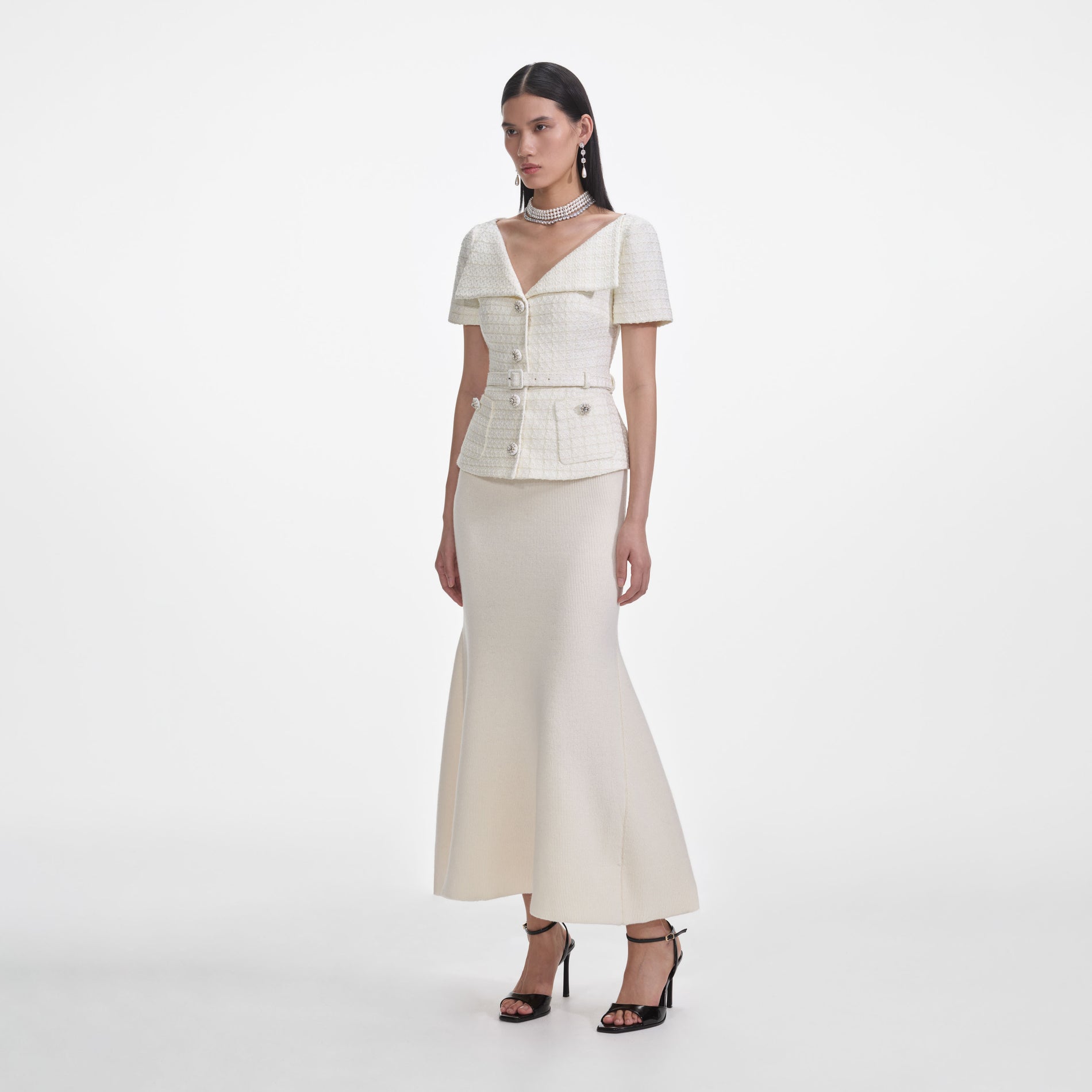 Side view of a woman wearing the Cream Boucle Top