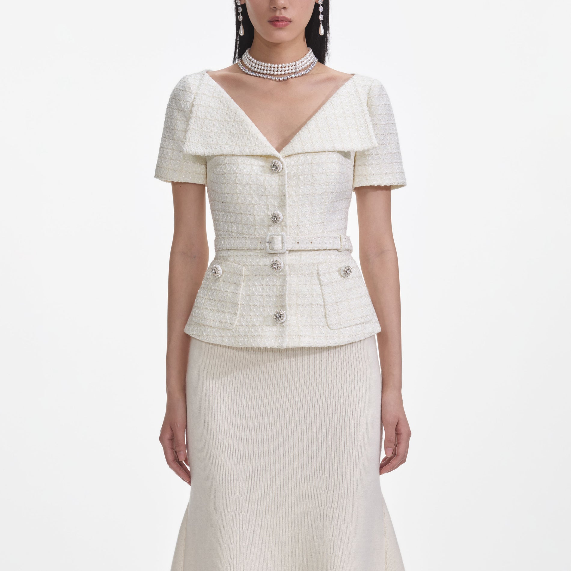 A close up of a woman wearing the Cream Boucle Top