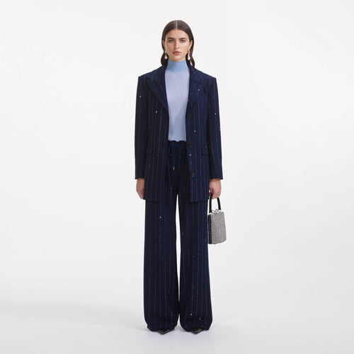 Front view of a woman wearing the Navy Rhinestone Pinstripe Trousers