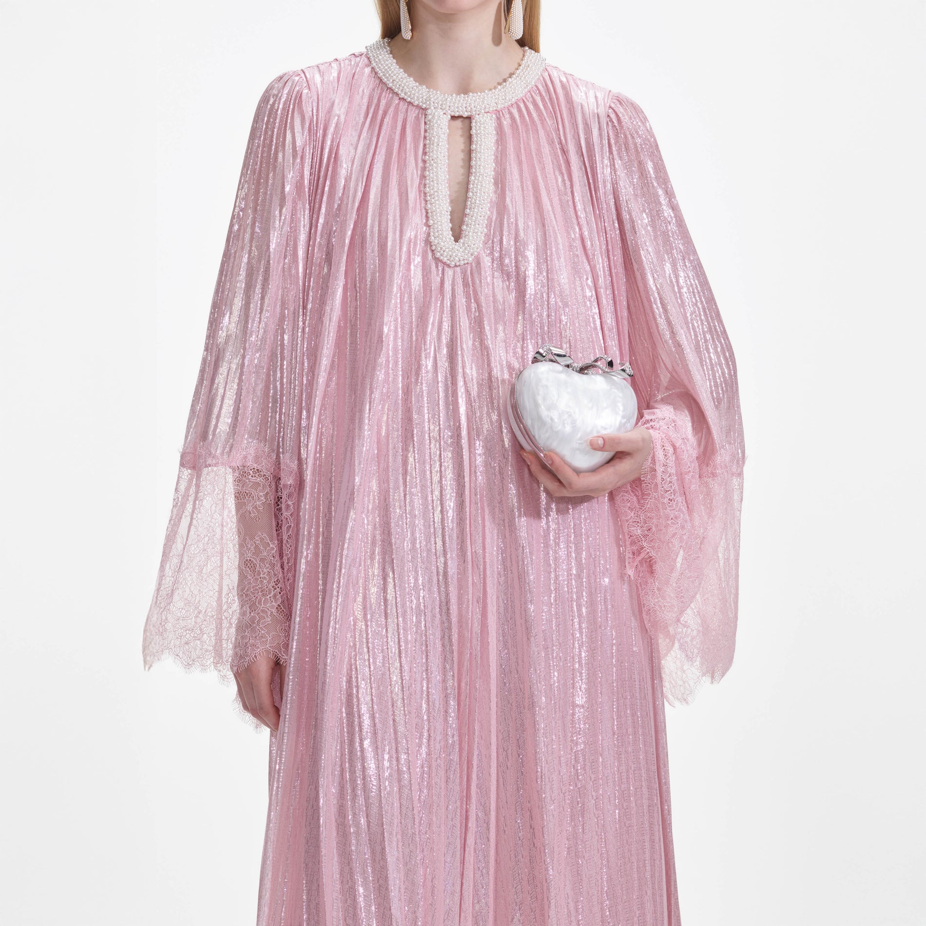 A close up of a woman wearing the Pink Metallic Pearl Maxi Dress