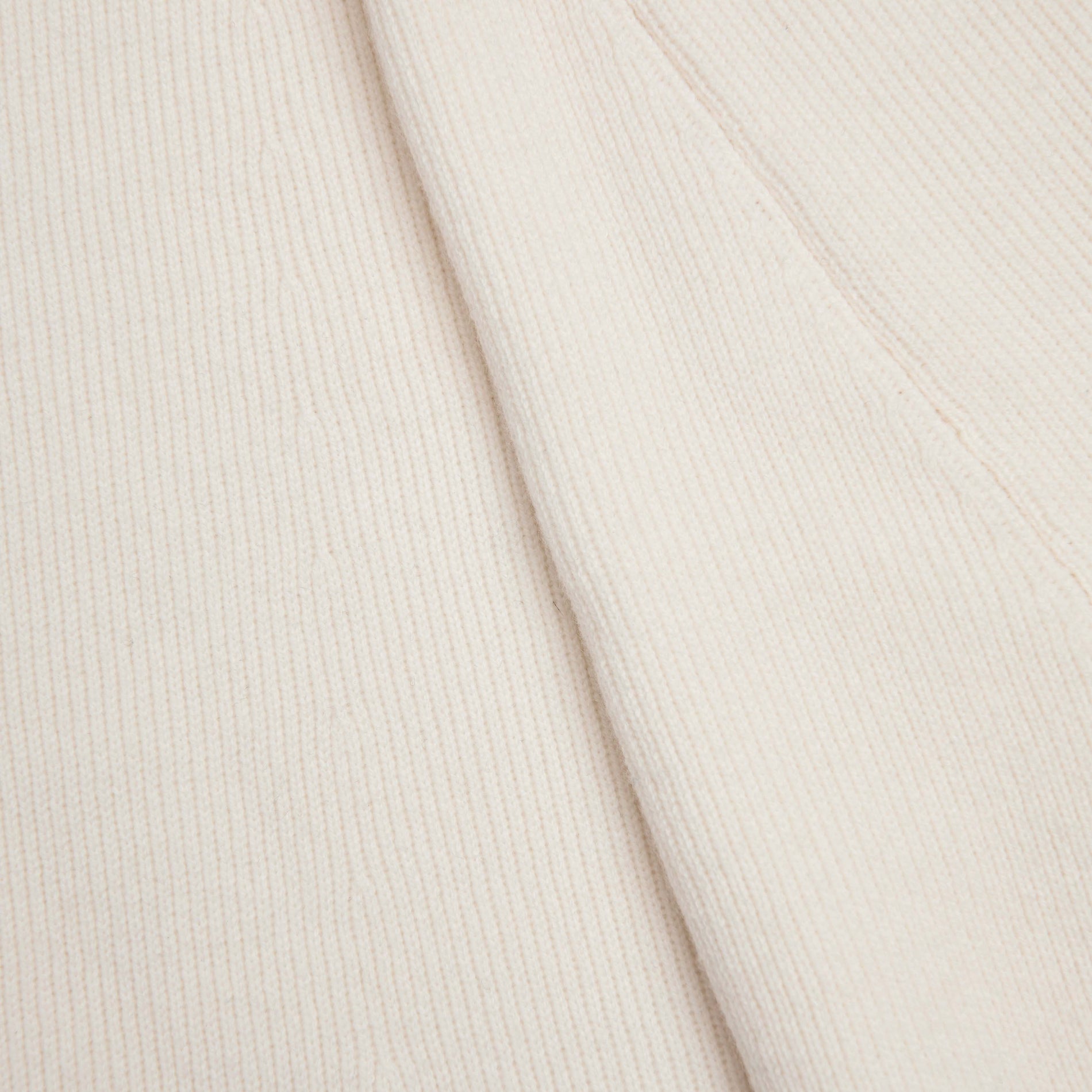 Side view of a woman wearing the Cream Flared Knit Midi Skirt