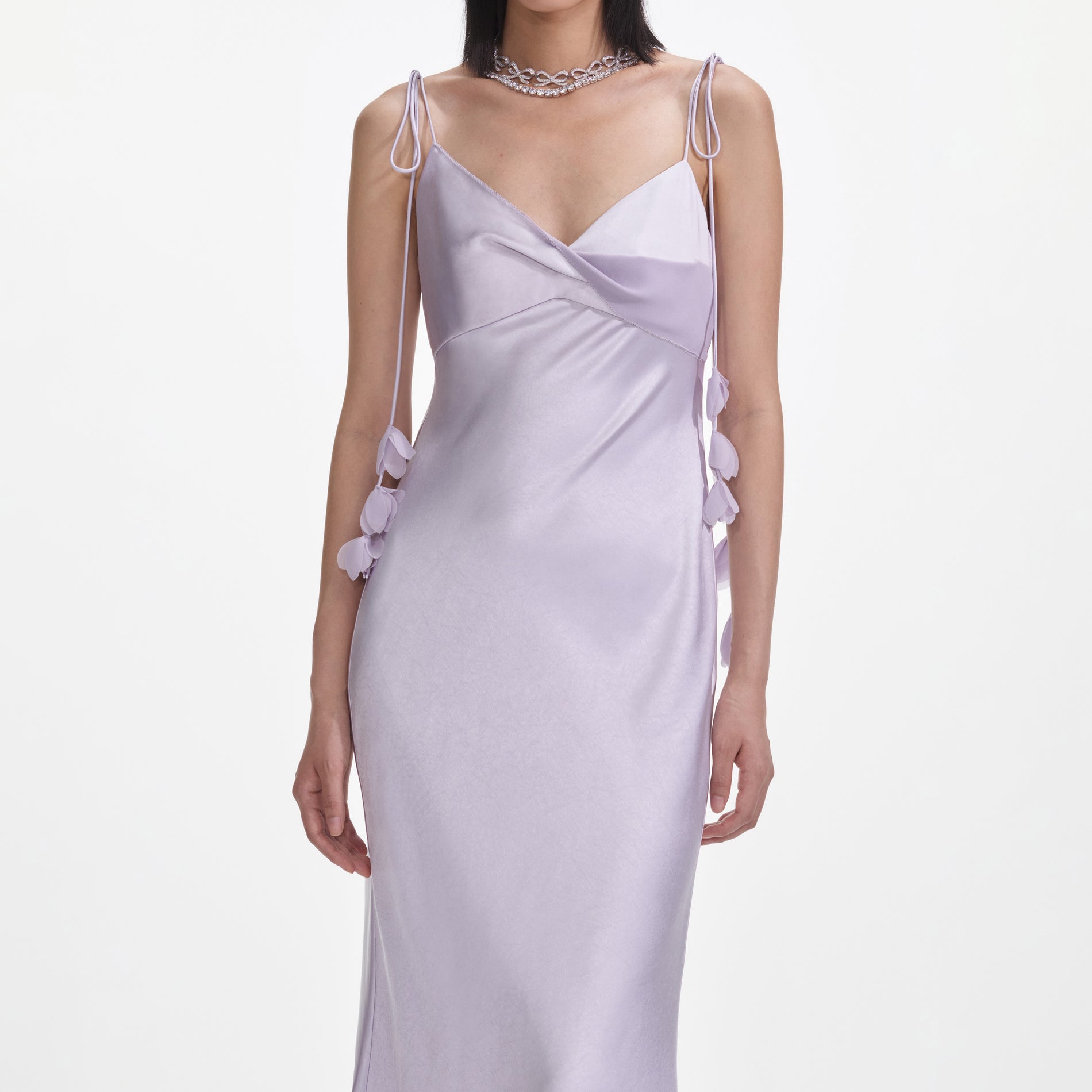 A close up of a woman wearing the Lilac Flower Satin Maxi Dress