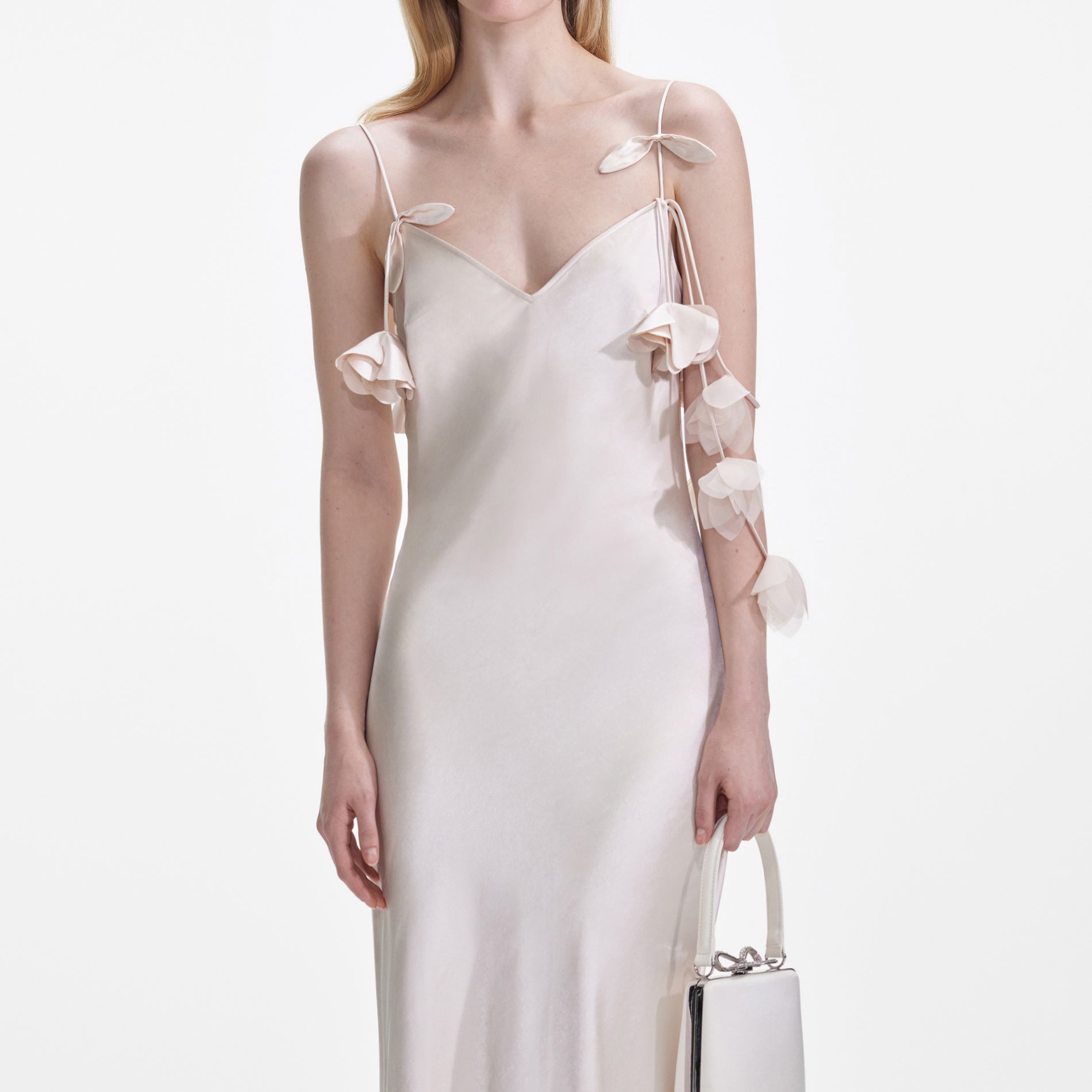 A close up of a woman wearing the Champagne Flower Satin Maxi Dress