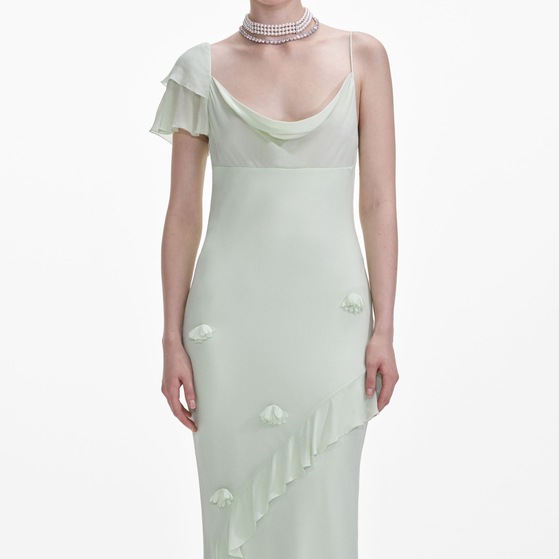 A close up of a woman wearing the Mint Georgette Flower Maxi Dress