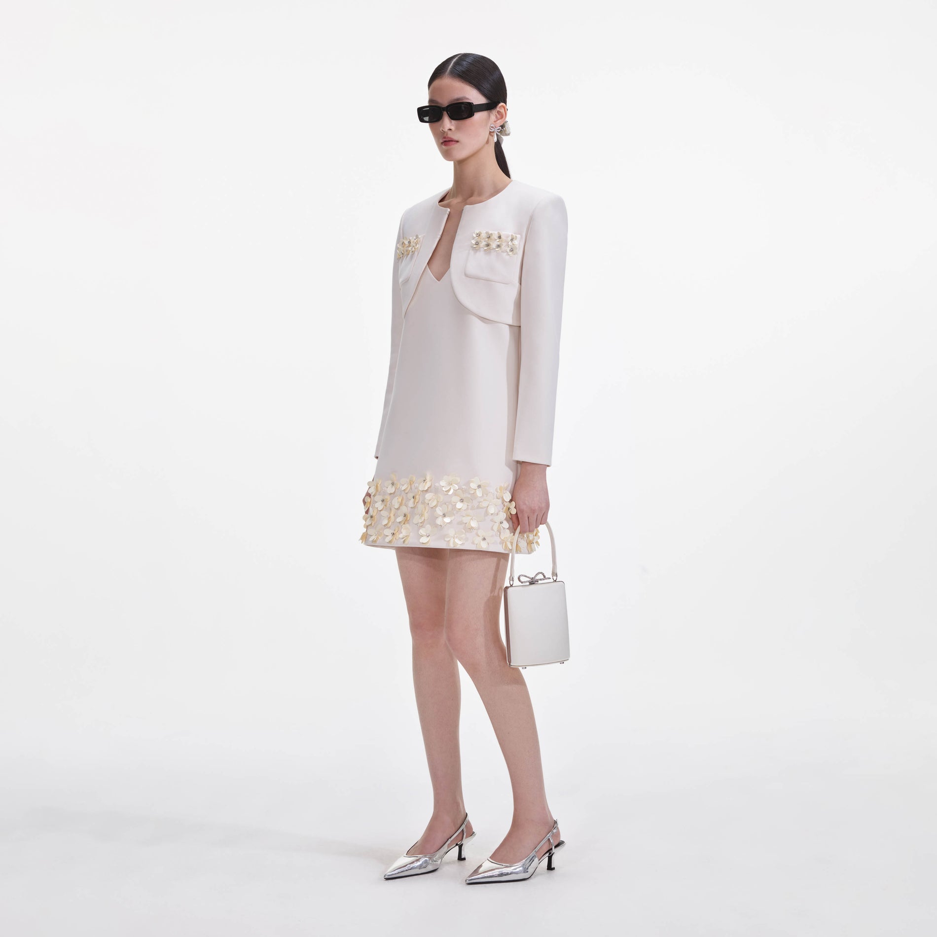 Side view of a woman wearing the Cream Crepe 3D Sequin Jacket