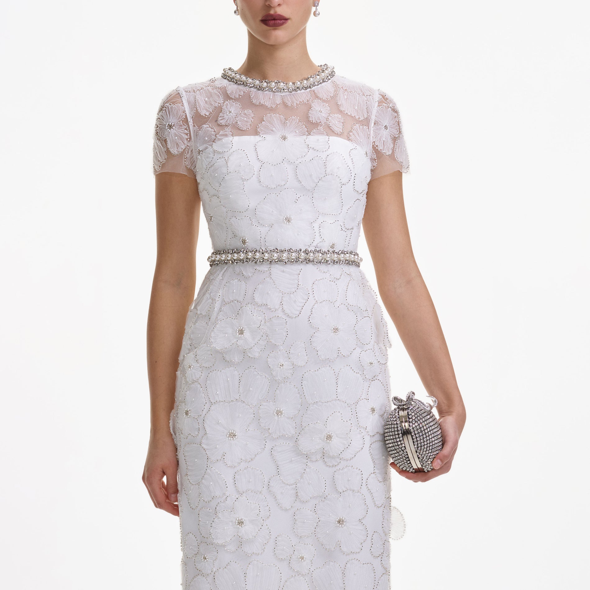 A close up of a woman wearing the White Embellished Tulle Midi Dress
