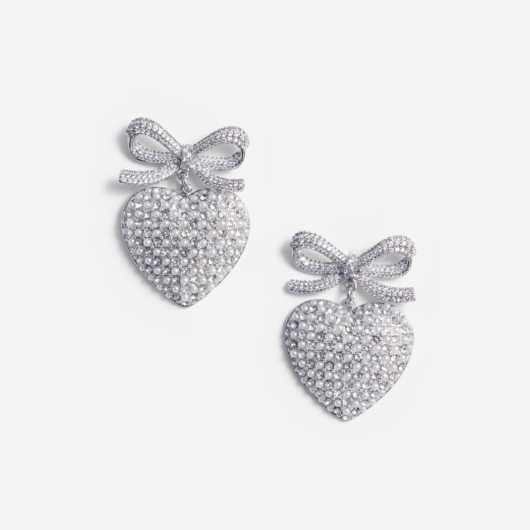 A photo of the Crystal Bow Pearl Heart Earrings