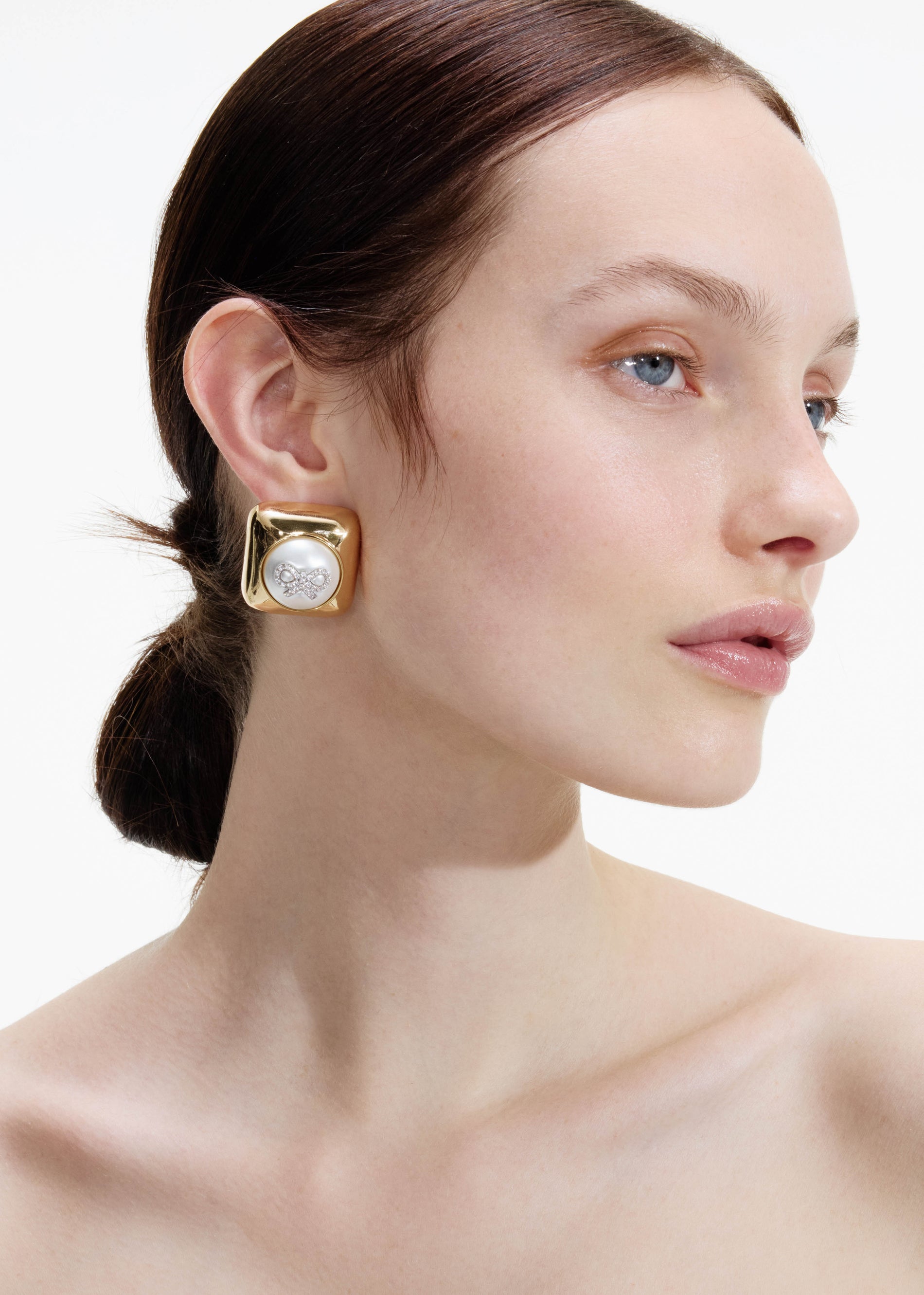 A photo of the Bow Pearl Gold Square Earrings