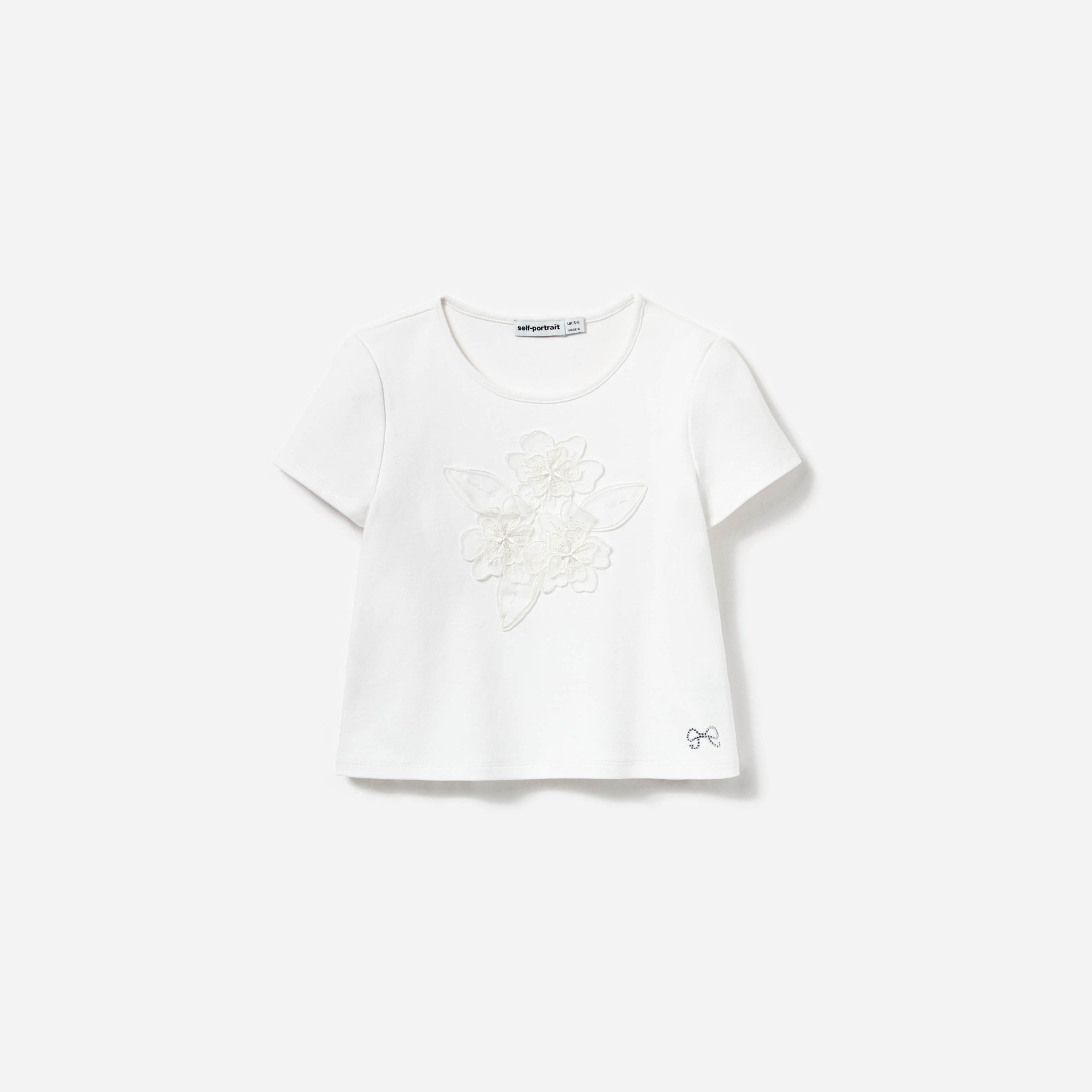 Front view of a woman wearing the Cream Jersey Flower Top