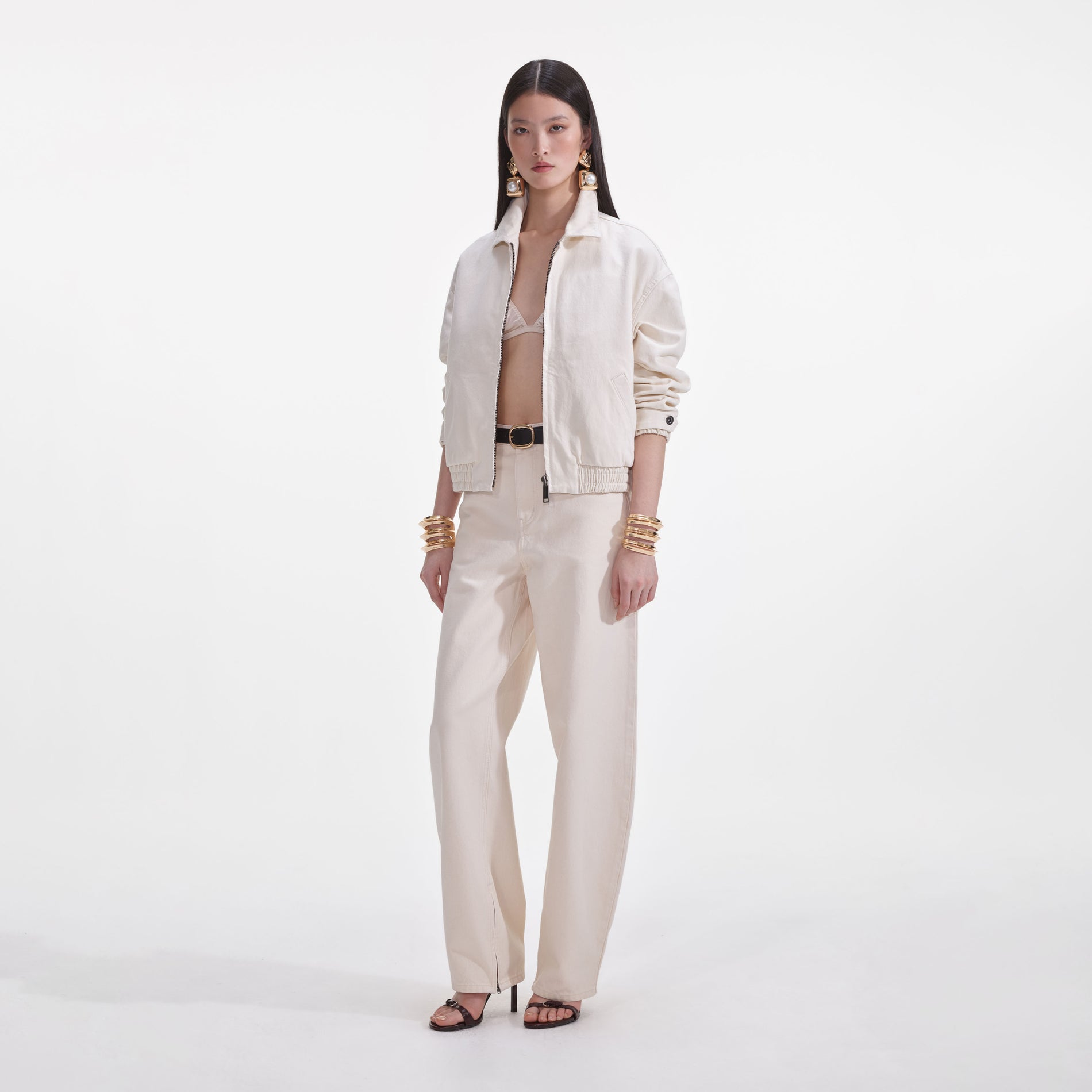 Side view of a woman wearing the Cream Lightweight Denim Jacket