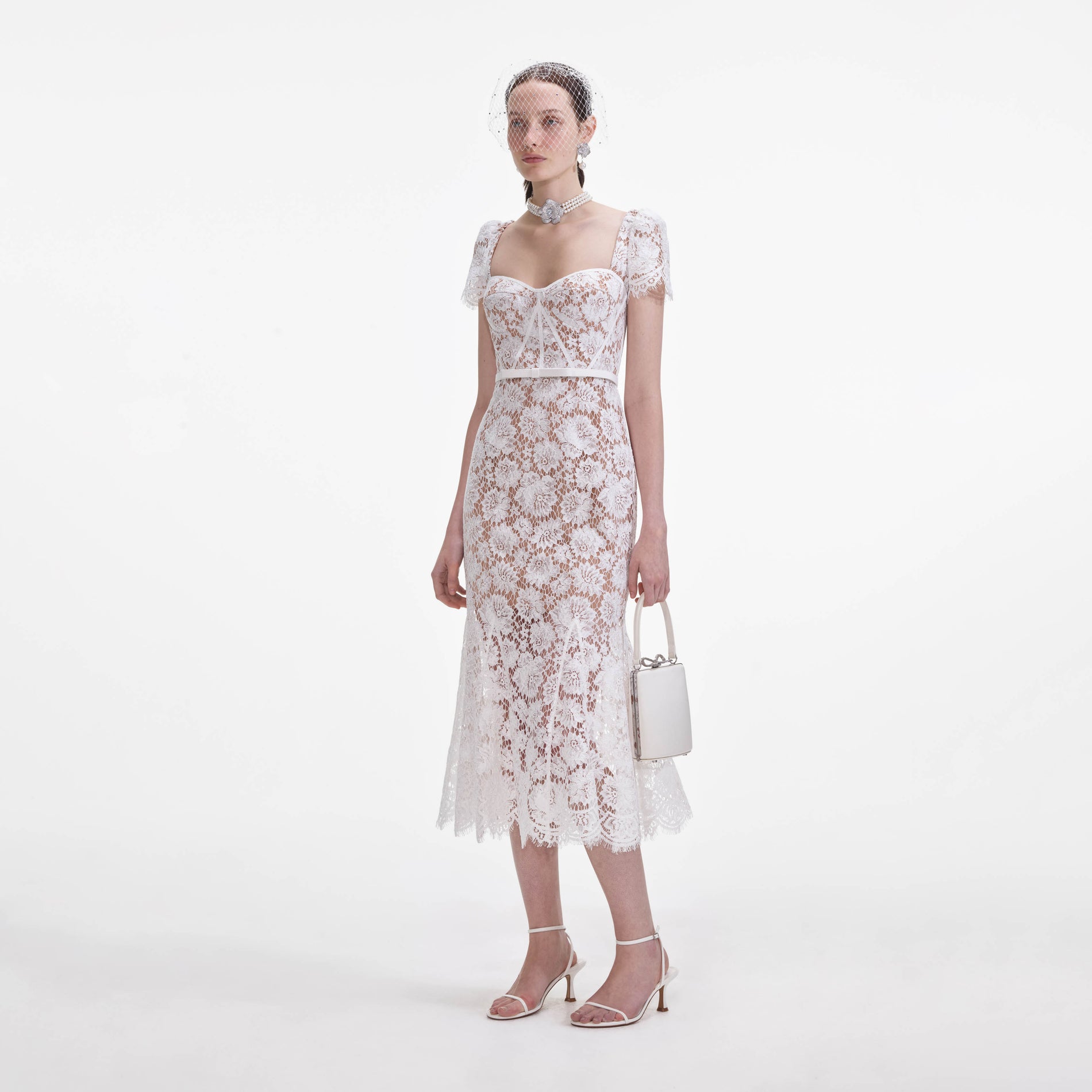 Side view of a woman wearing the White Fine Lace Midi Dress