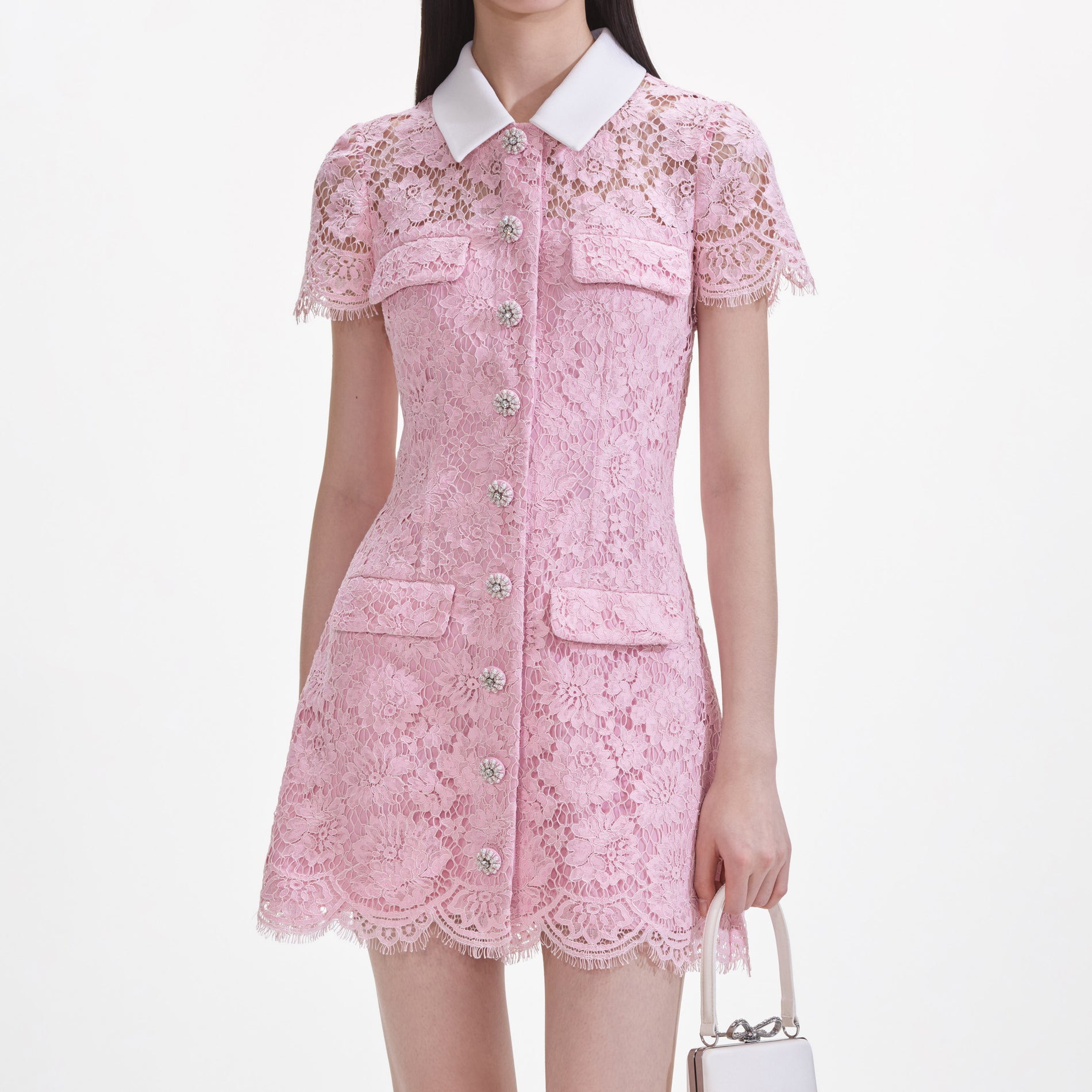 A close up of a woman wearing the Pink Lace Collared Mini Dress