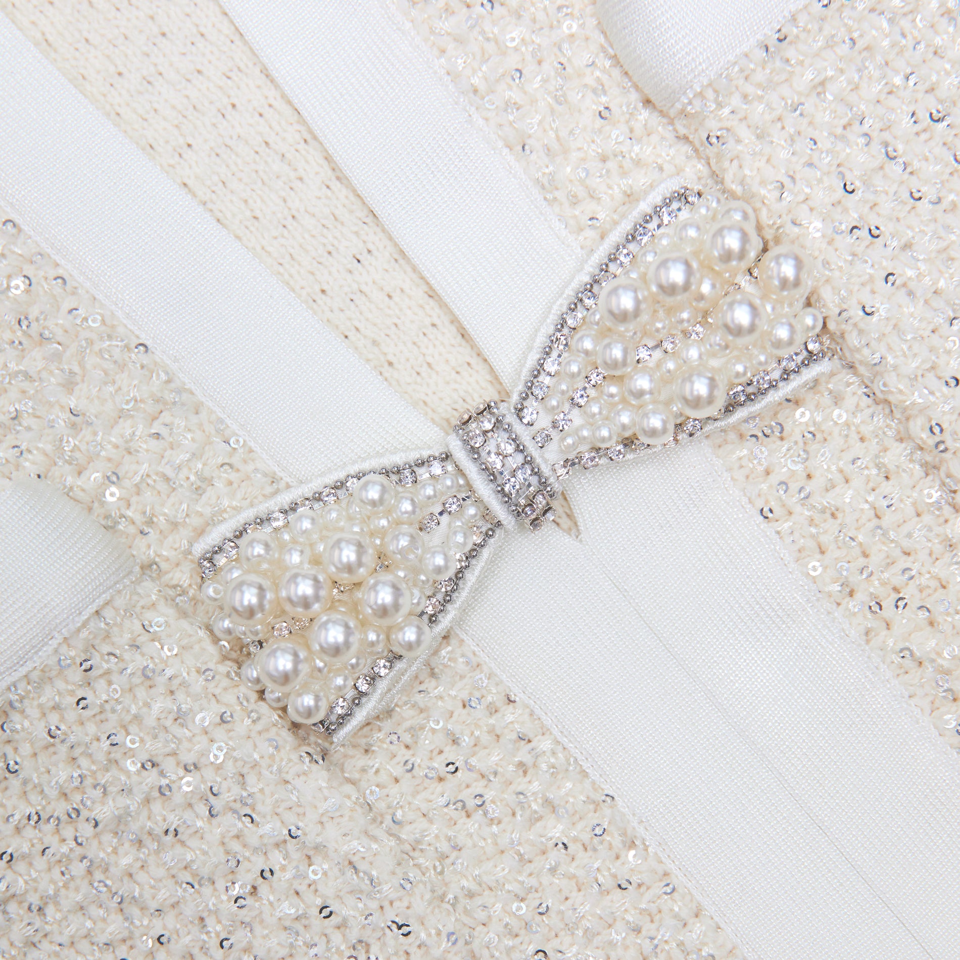 Side view of a woman wearing the Cream Sequin Knit Top