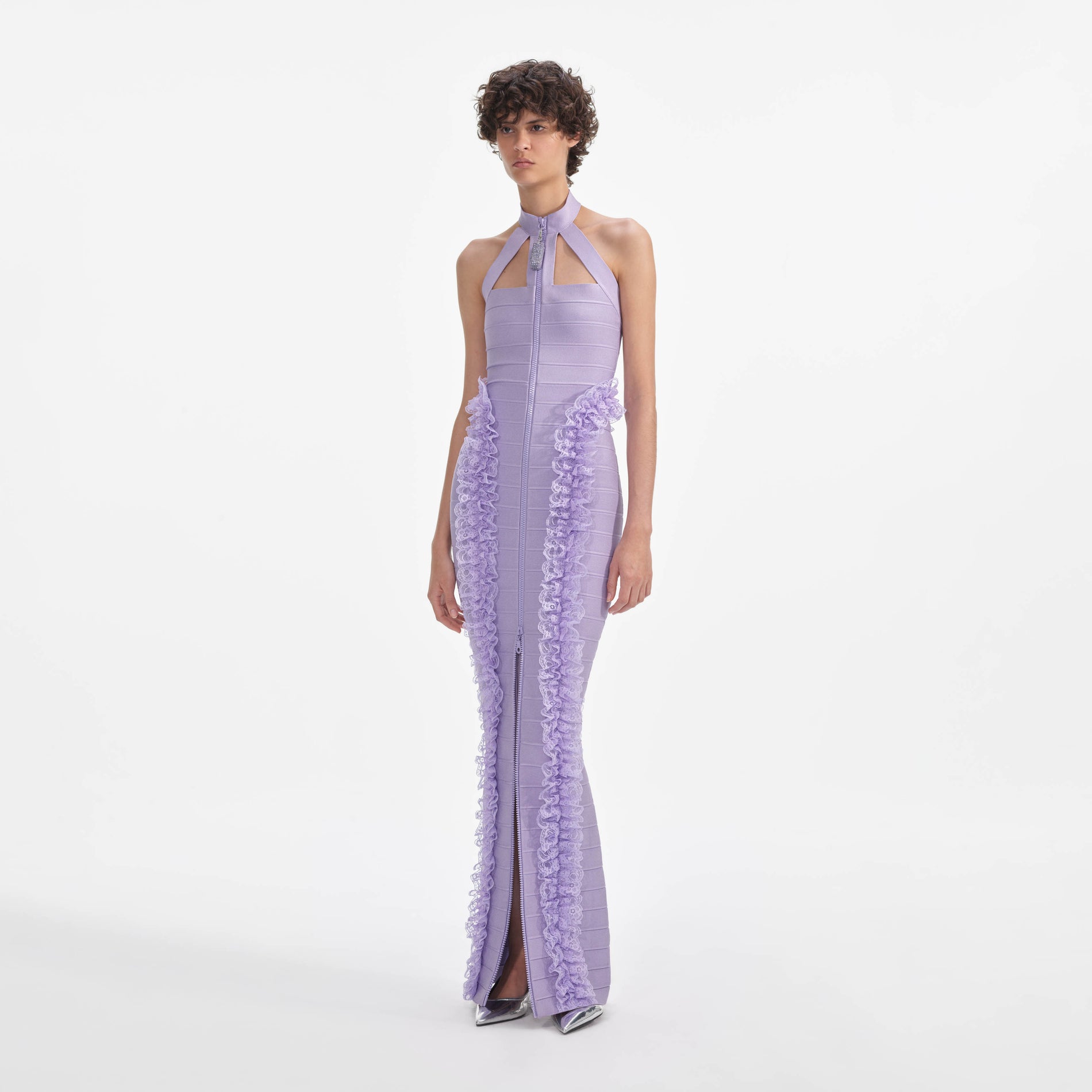Side view of a woman wearing the Purple Knit Zip Ruffle Maxi Dress