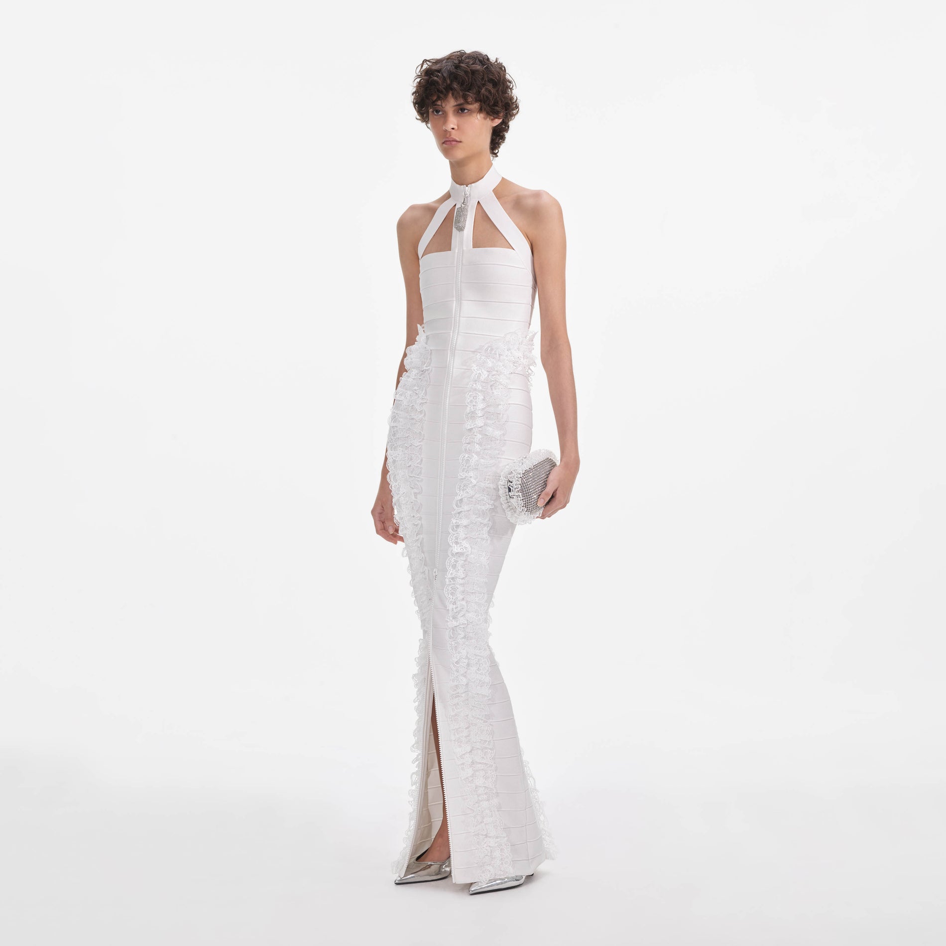 Side view of a woman wearing the White Knit Zip Ruffle Maxi Dress