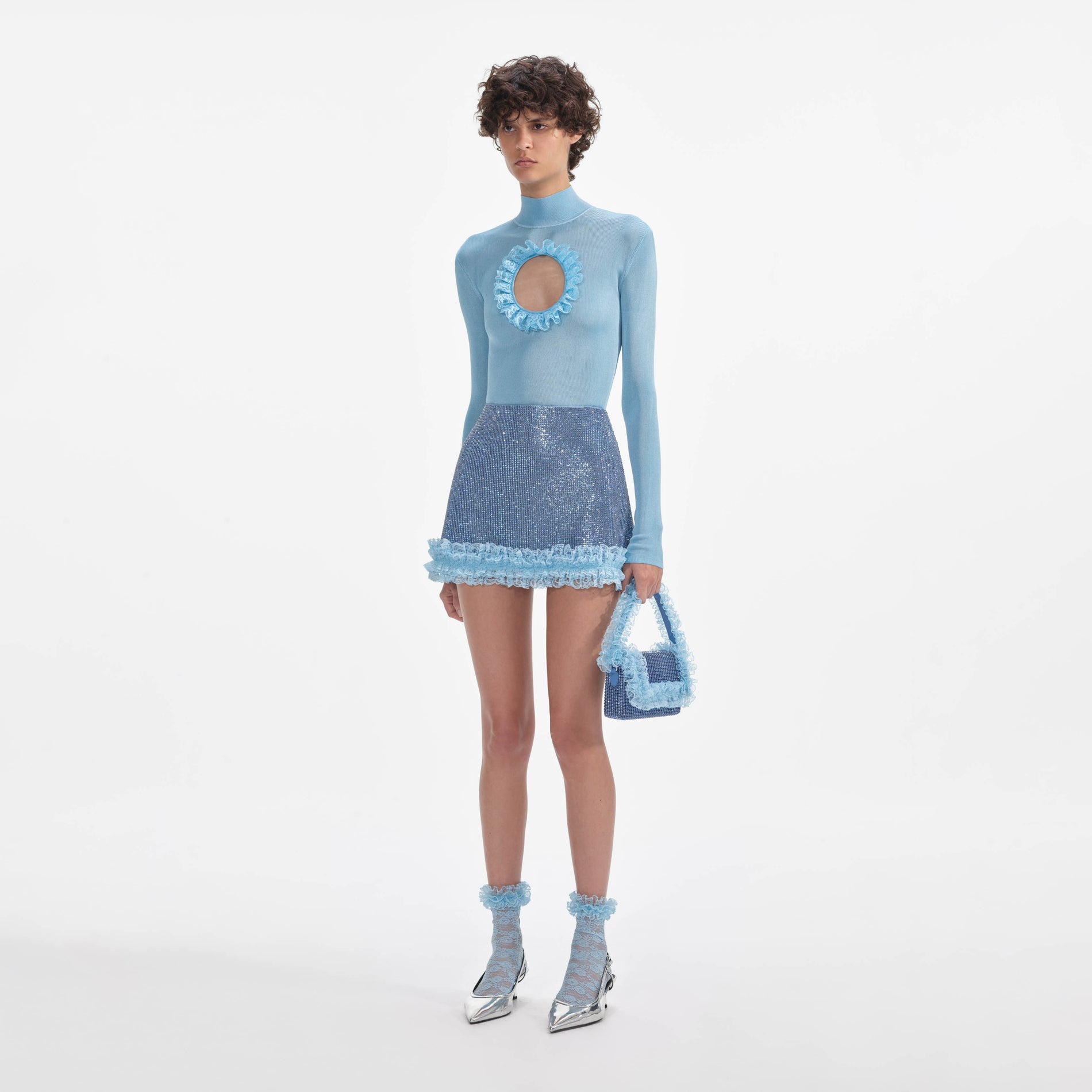 Side view of a woman wearing the Blue Knit Cut Out Bodysuit