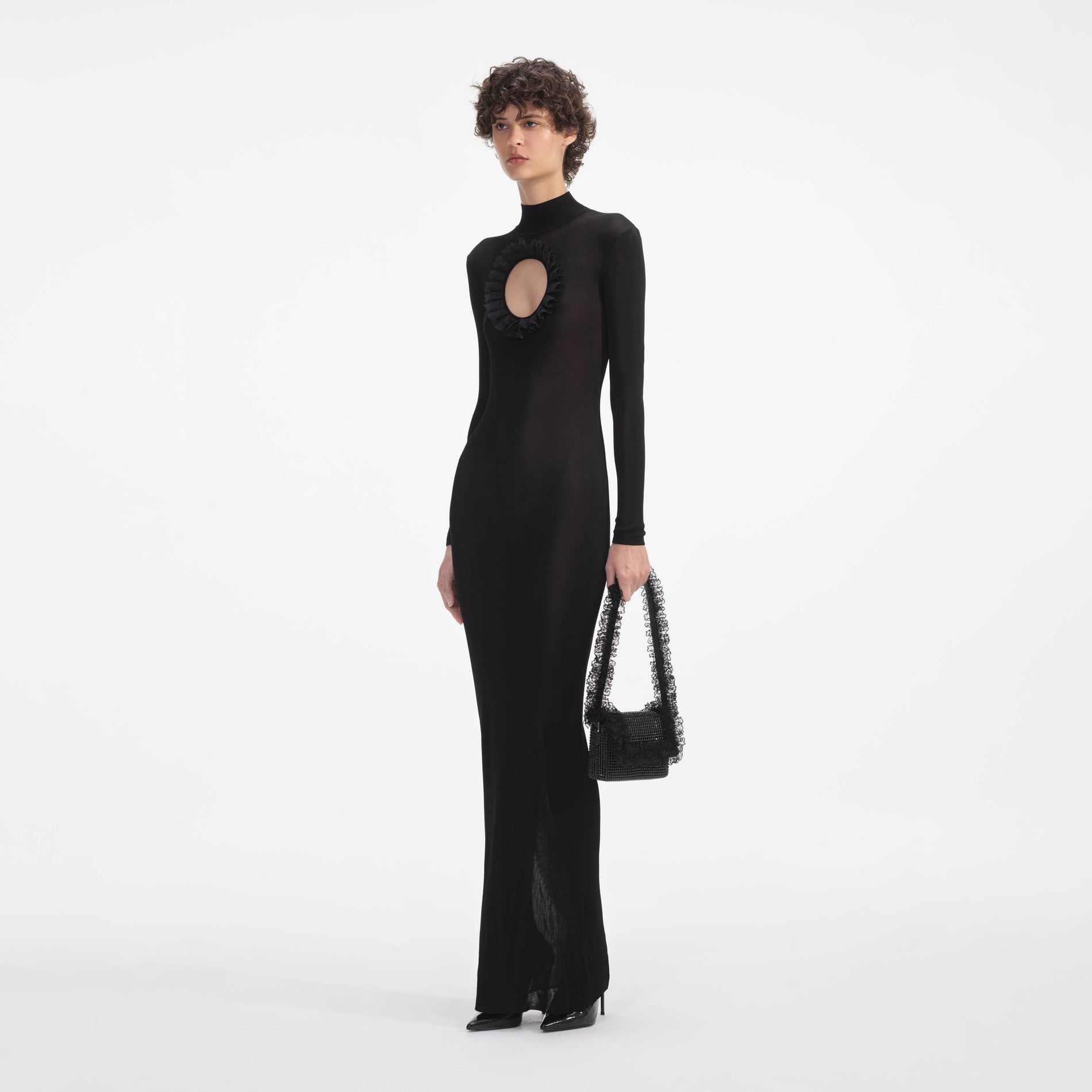 Side view of a woman wearing the Black Knit Cut Out Maxi Dress