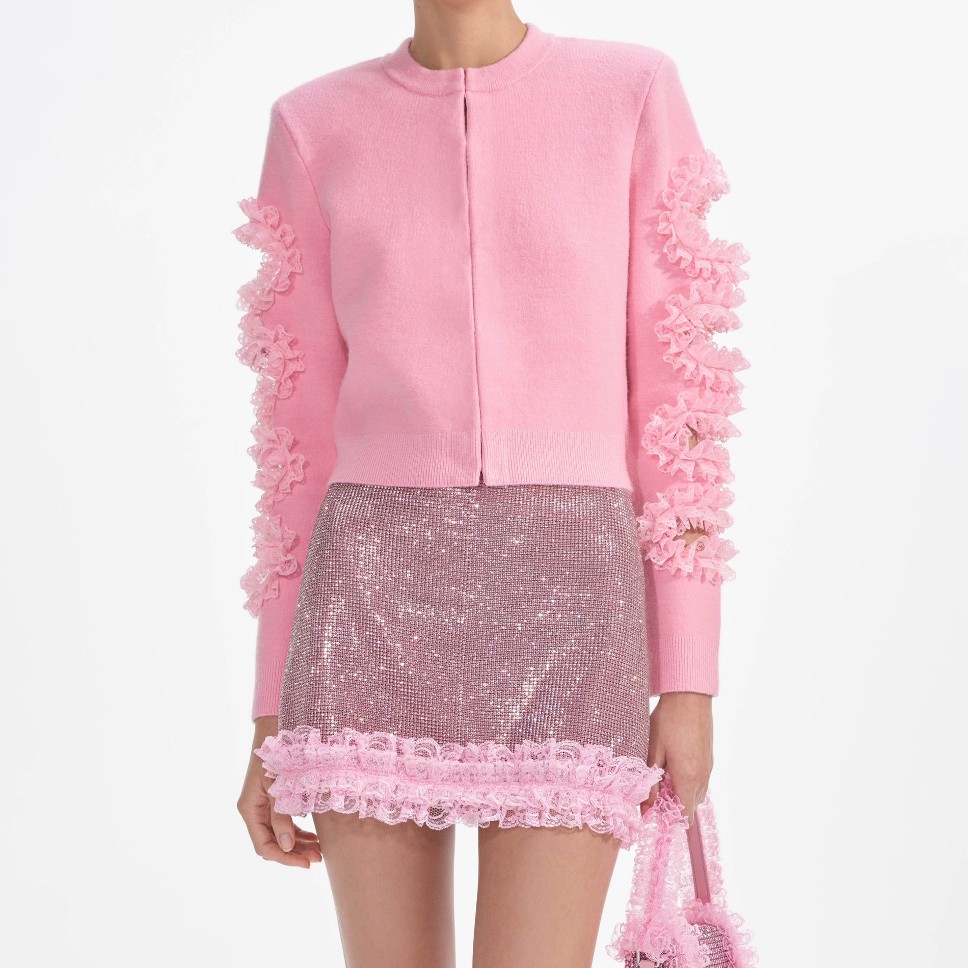 A close up of a woman wearing the Pink Cut Out Lace Detail Cardigan