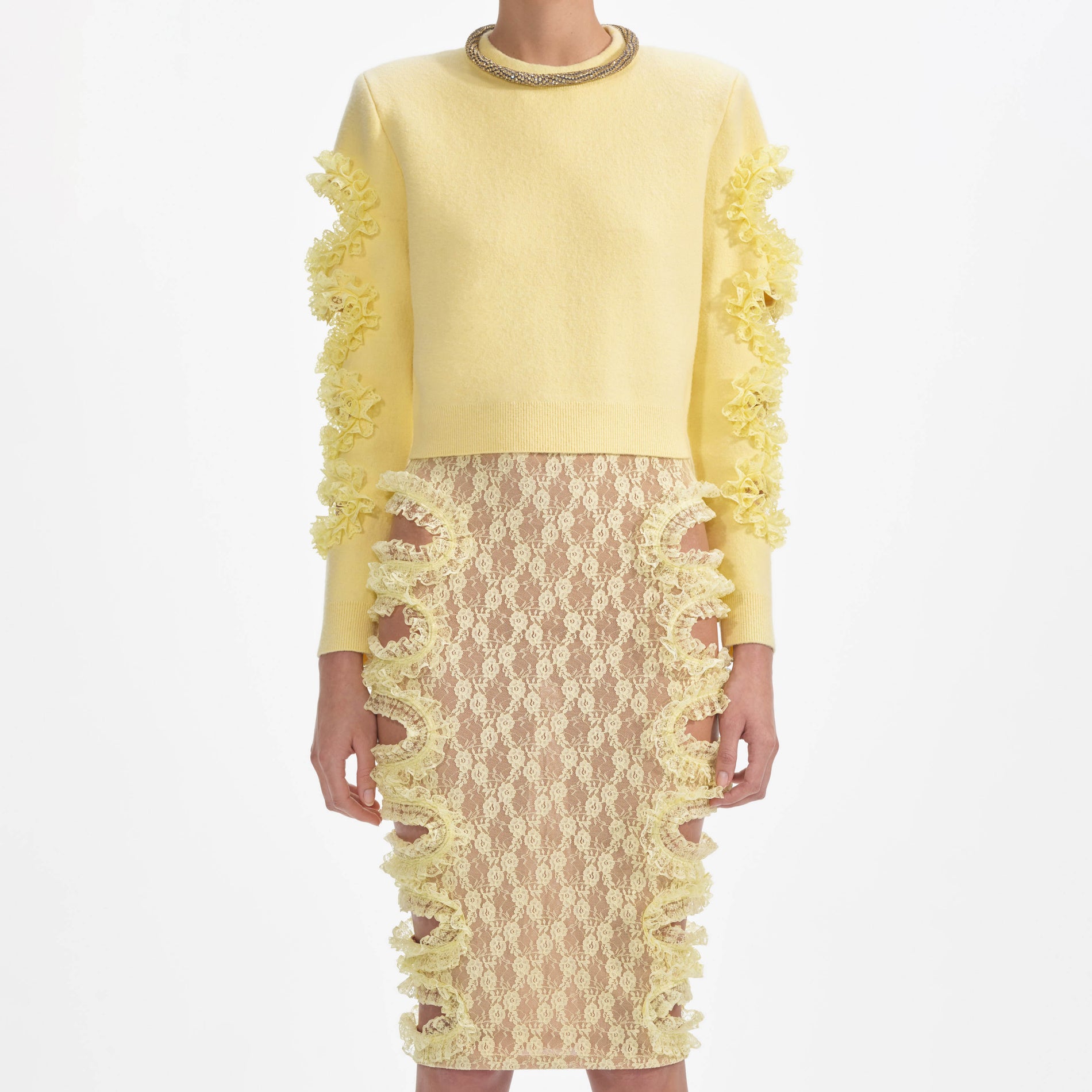 A close up of a woman wearing the Yellow Lace Cut Out Midi Skirt