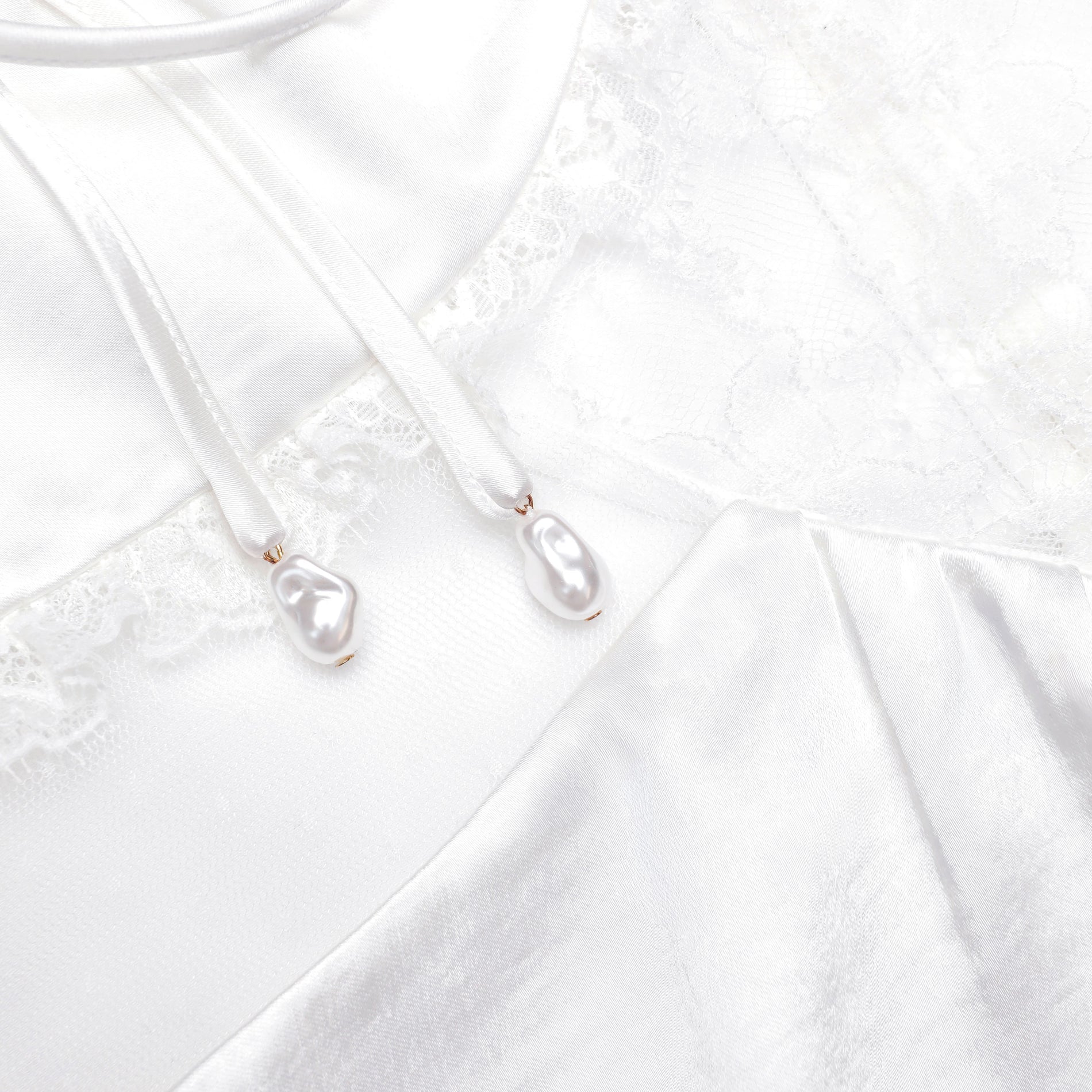 A close up of the fabric for the White Satin Lace Top