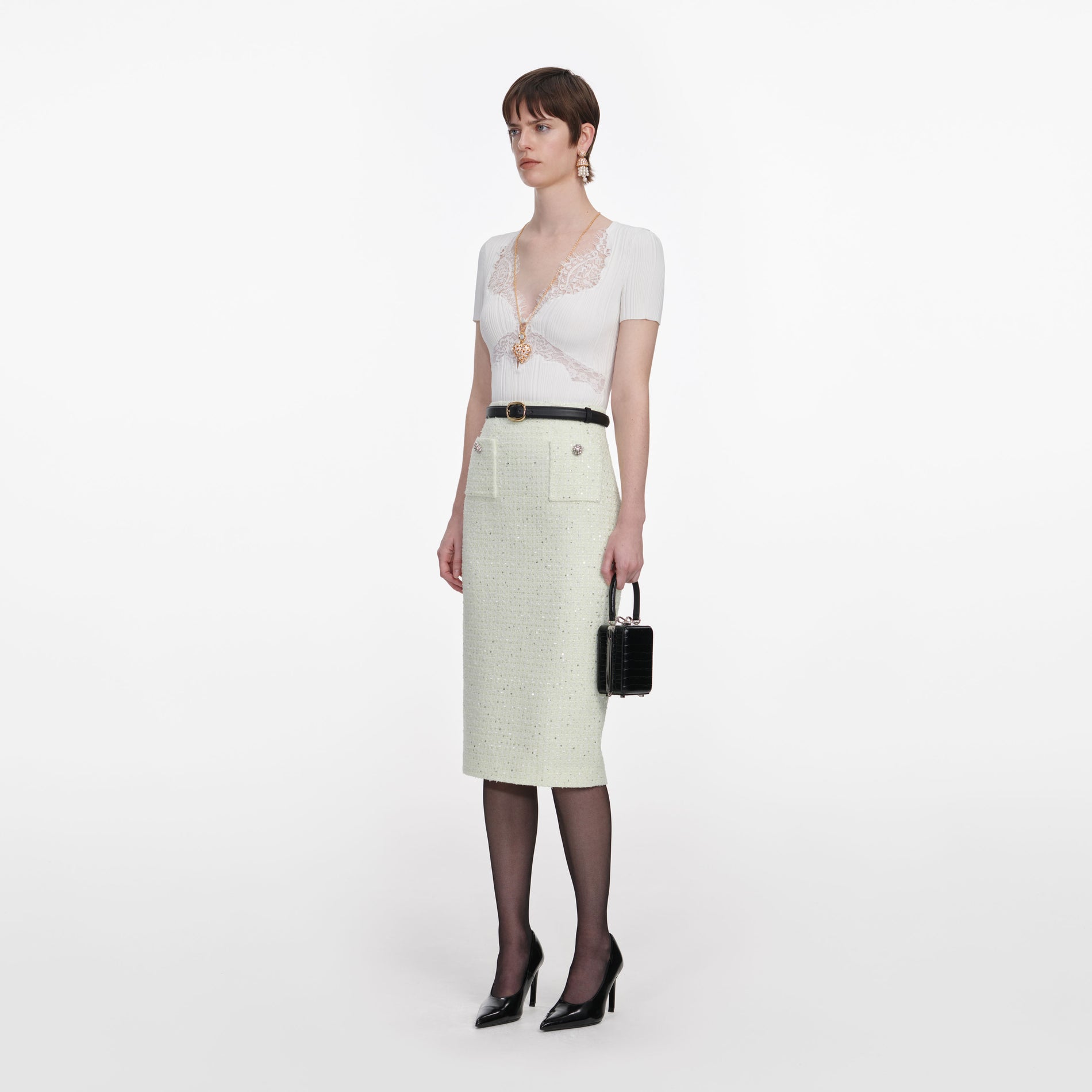 Side view of a woman wearing the Lime Boucle Midi Skirt