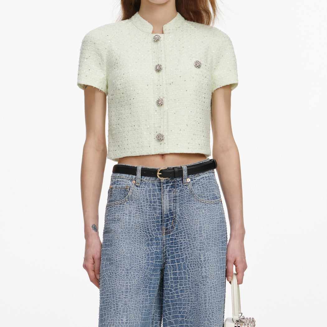 A close up of a woman wearing the Lime Boucle Top